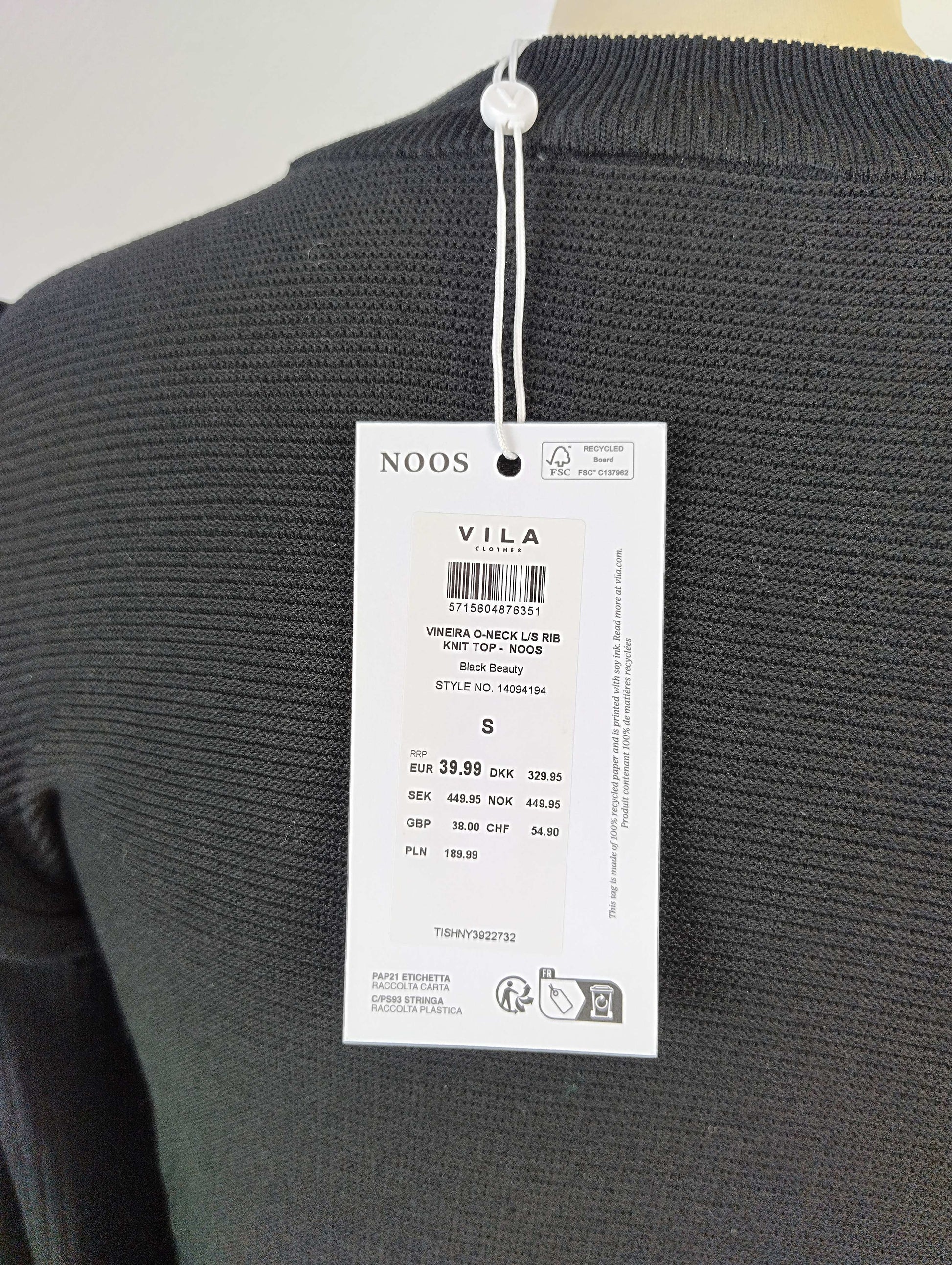 Tag details on black ribbed knit top