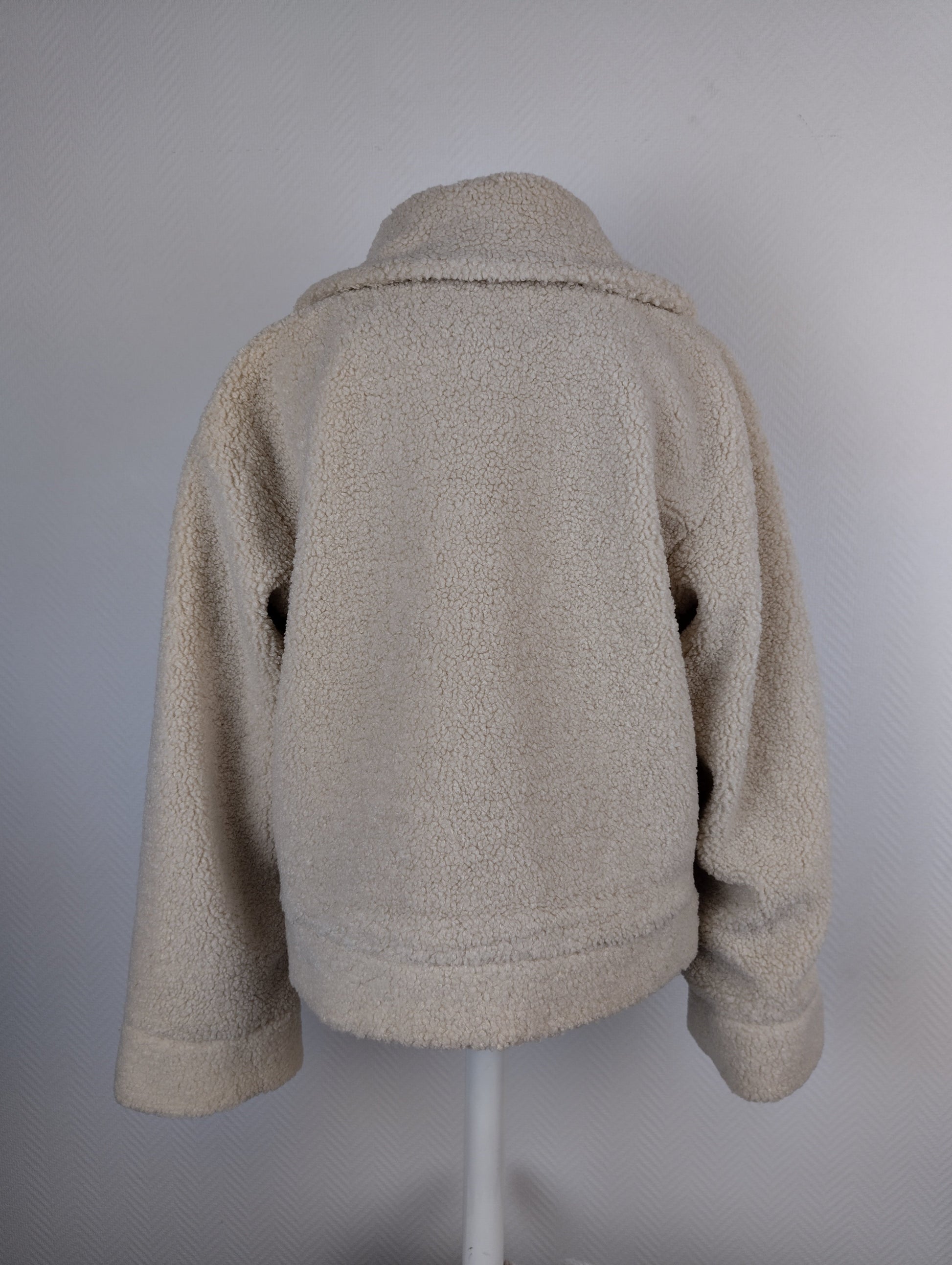 Back view of beige sherpa jacket