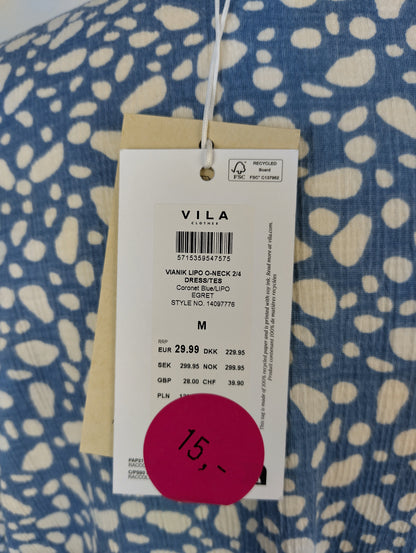 Tag on blue patterned Vila dress showing price and details
