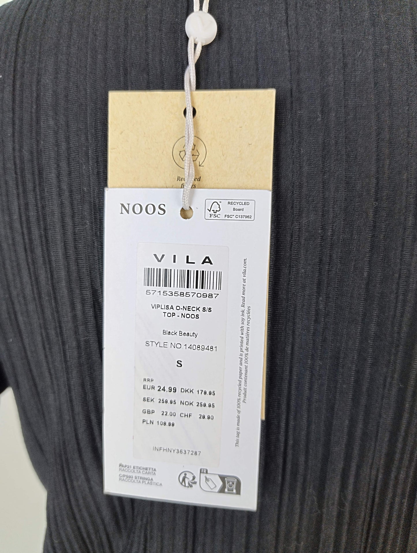 Close-up of label on black ribbed top