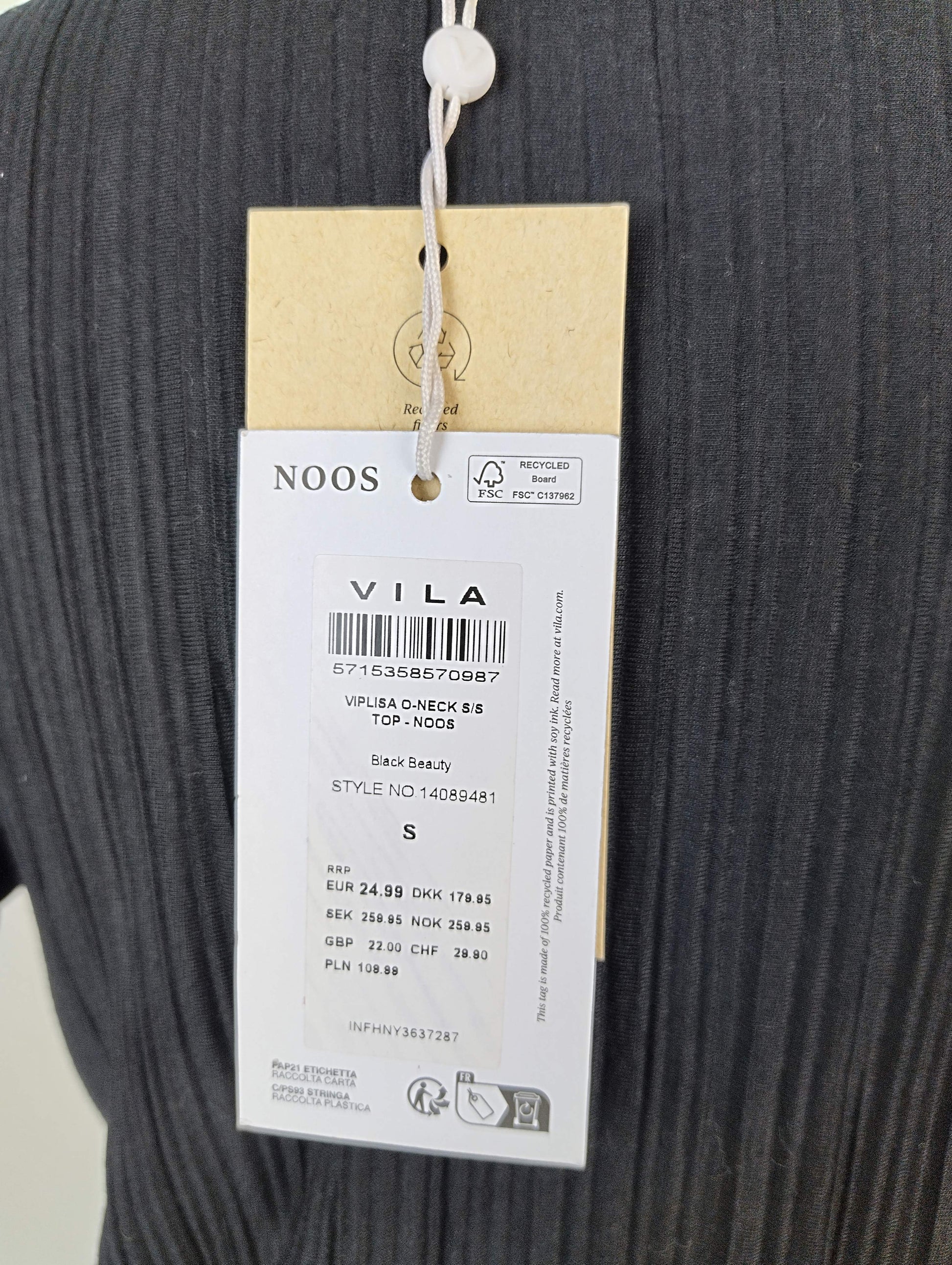 Close-up of label on black ribbed top