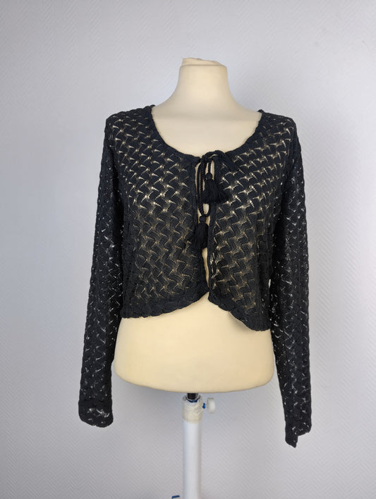 Front view of the black lace open-front cardigan with tassel ties