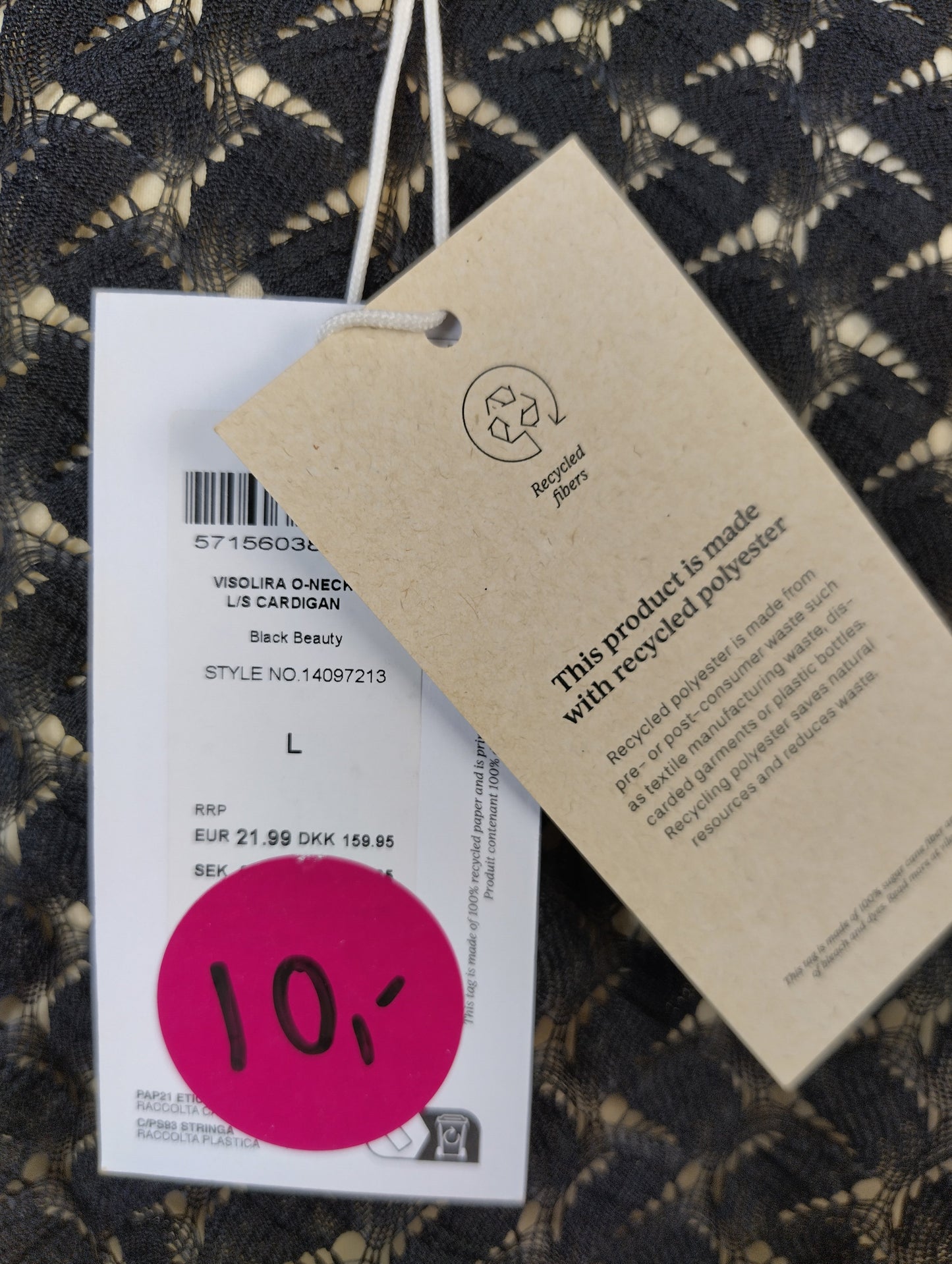 Close-up of the tag showing recycled polyester material and size
