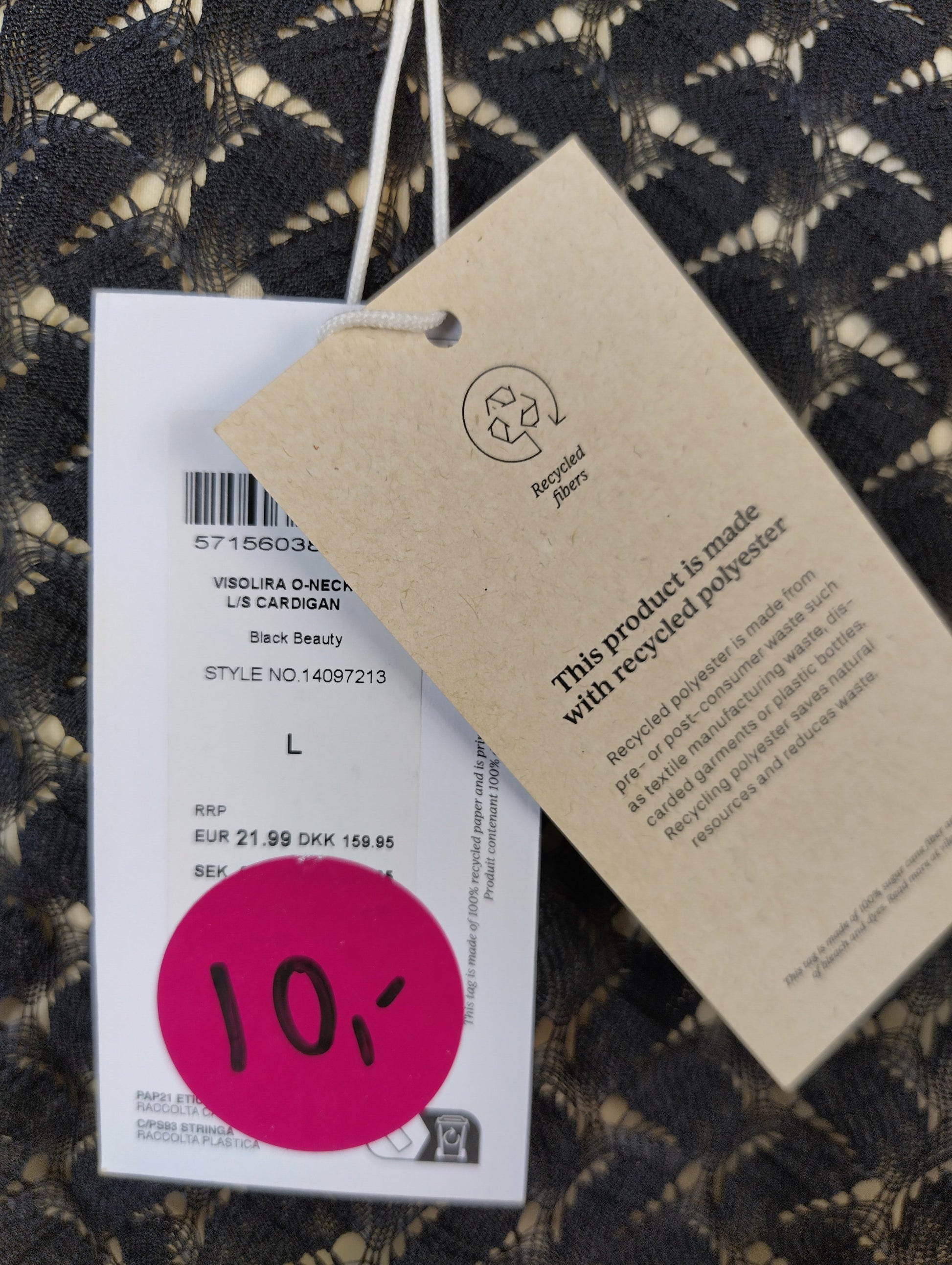 Close-up of the tag showing recycled polyester material and size