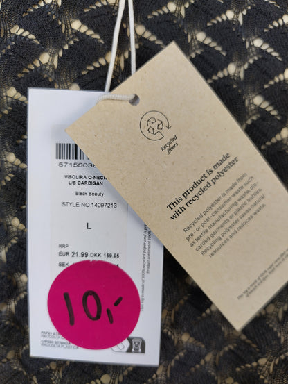 Close-up of the tag showing recycled polyester material and size