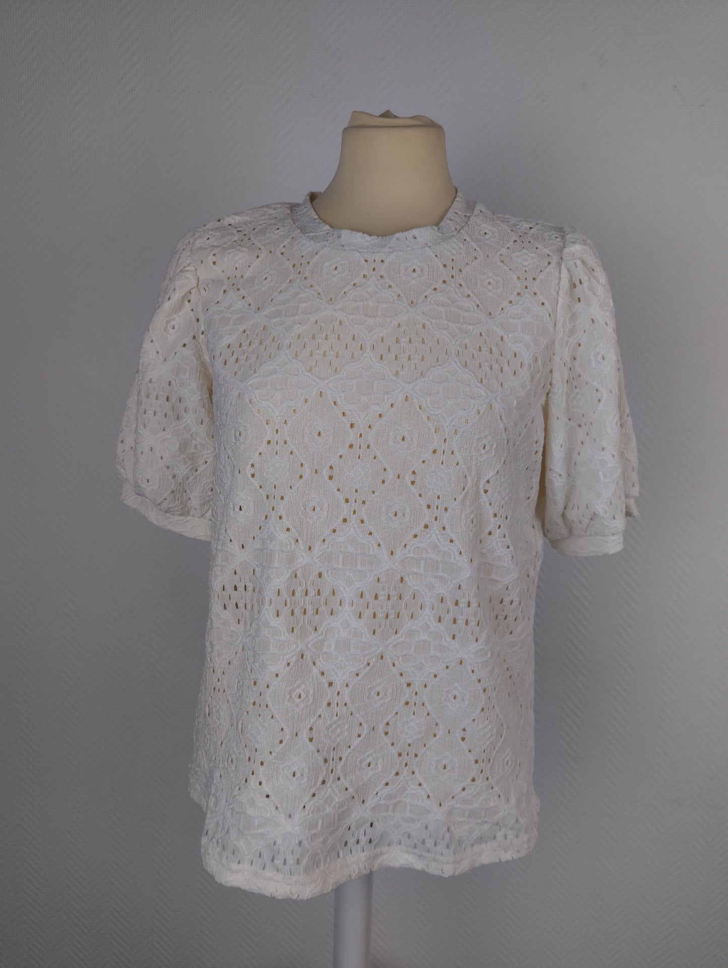Front view of white lace top on mannequin