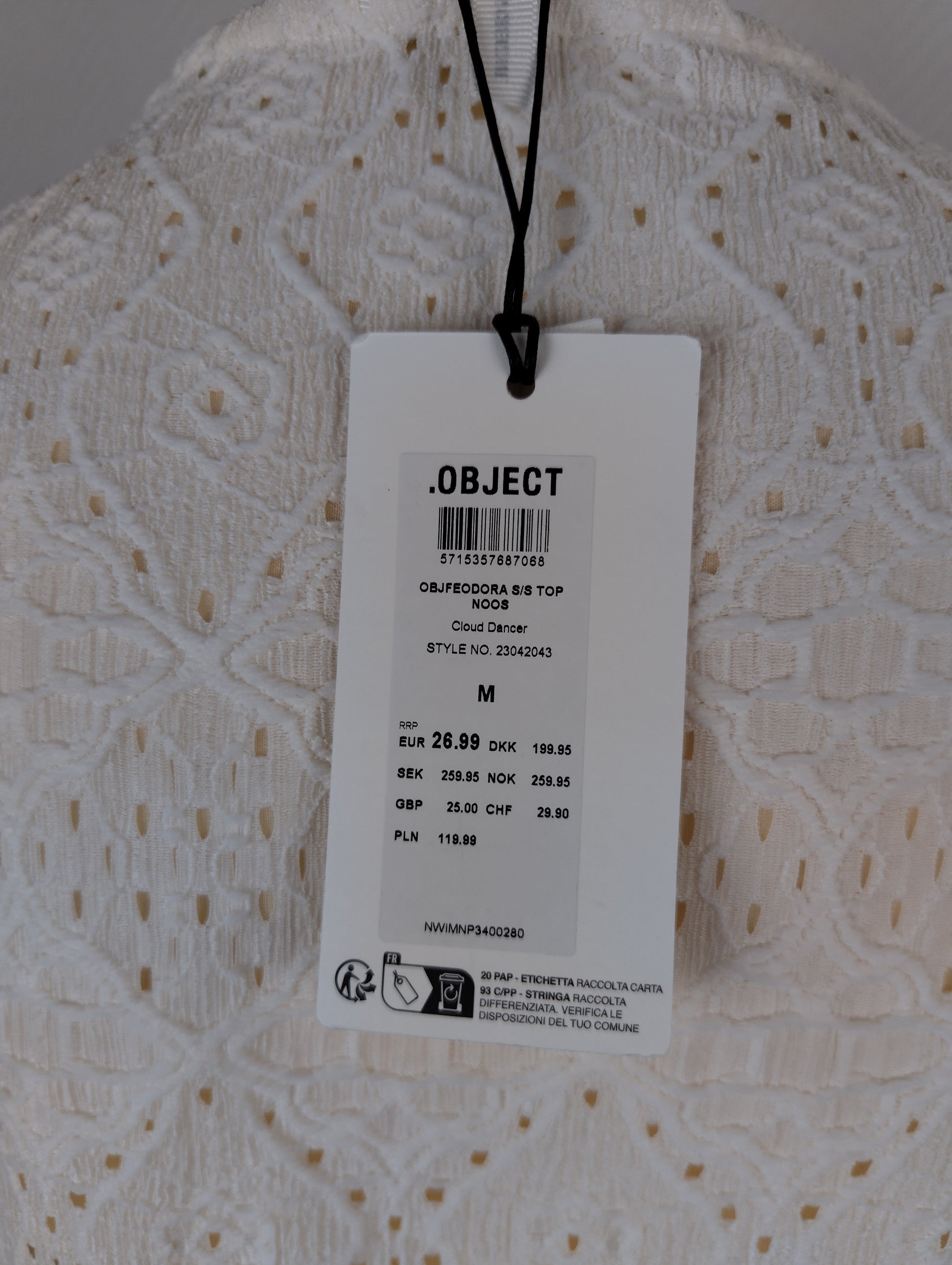 Close-up of tag on white lace top