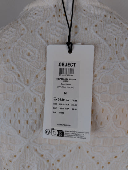 Close-up of tag on white lace top