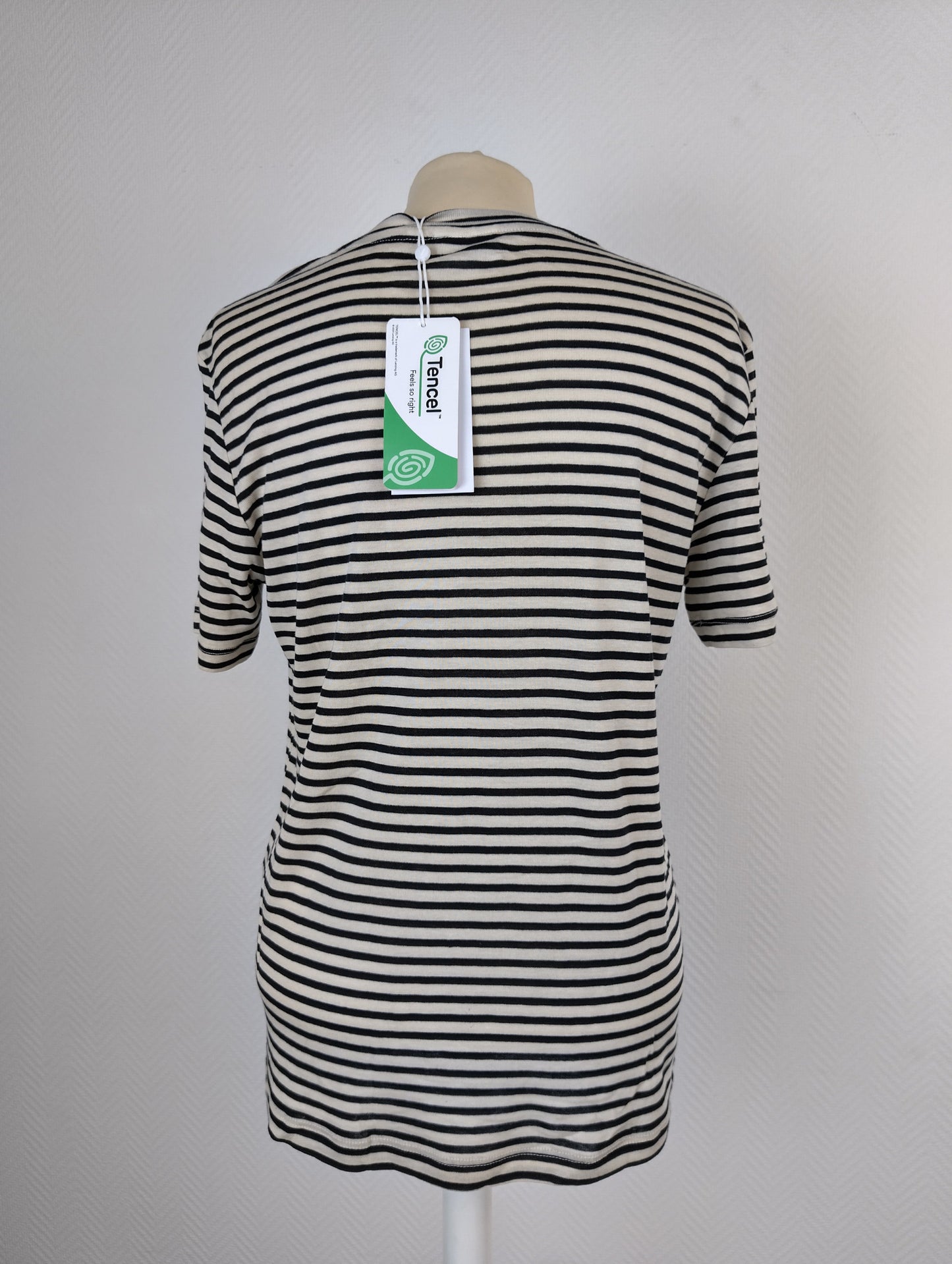 Back view of black and white striped T-shirt with tag
