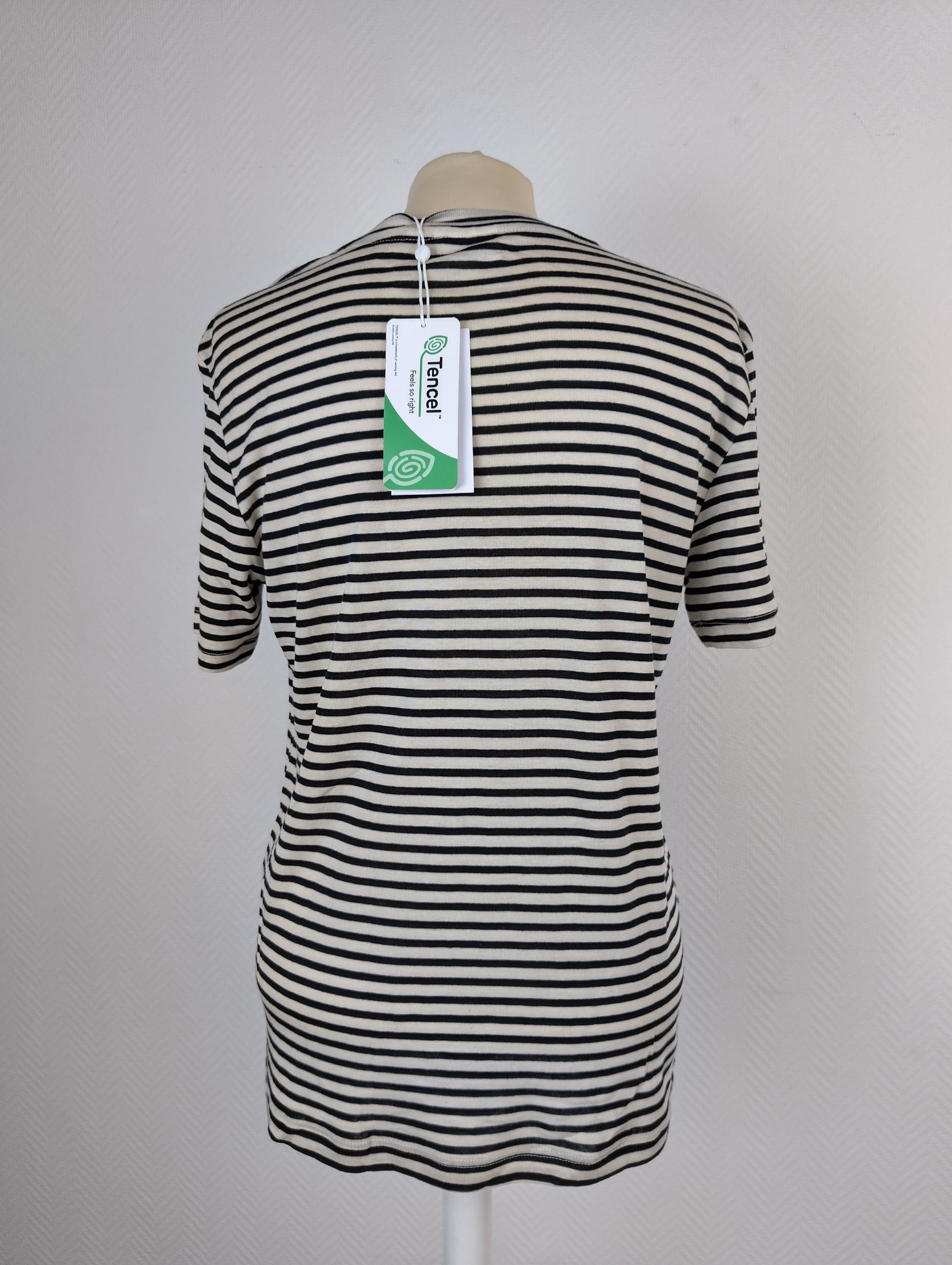 Back view of black and white striped T-shirt with tag