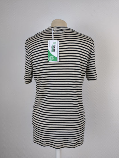 Back view of black and white striped T-shirt with tag
