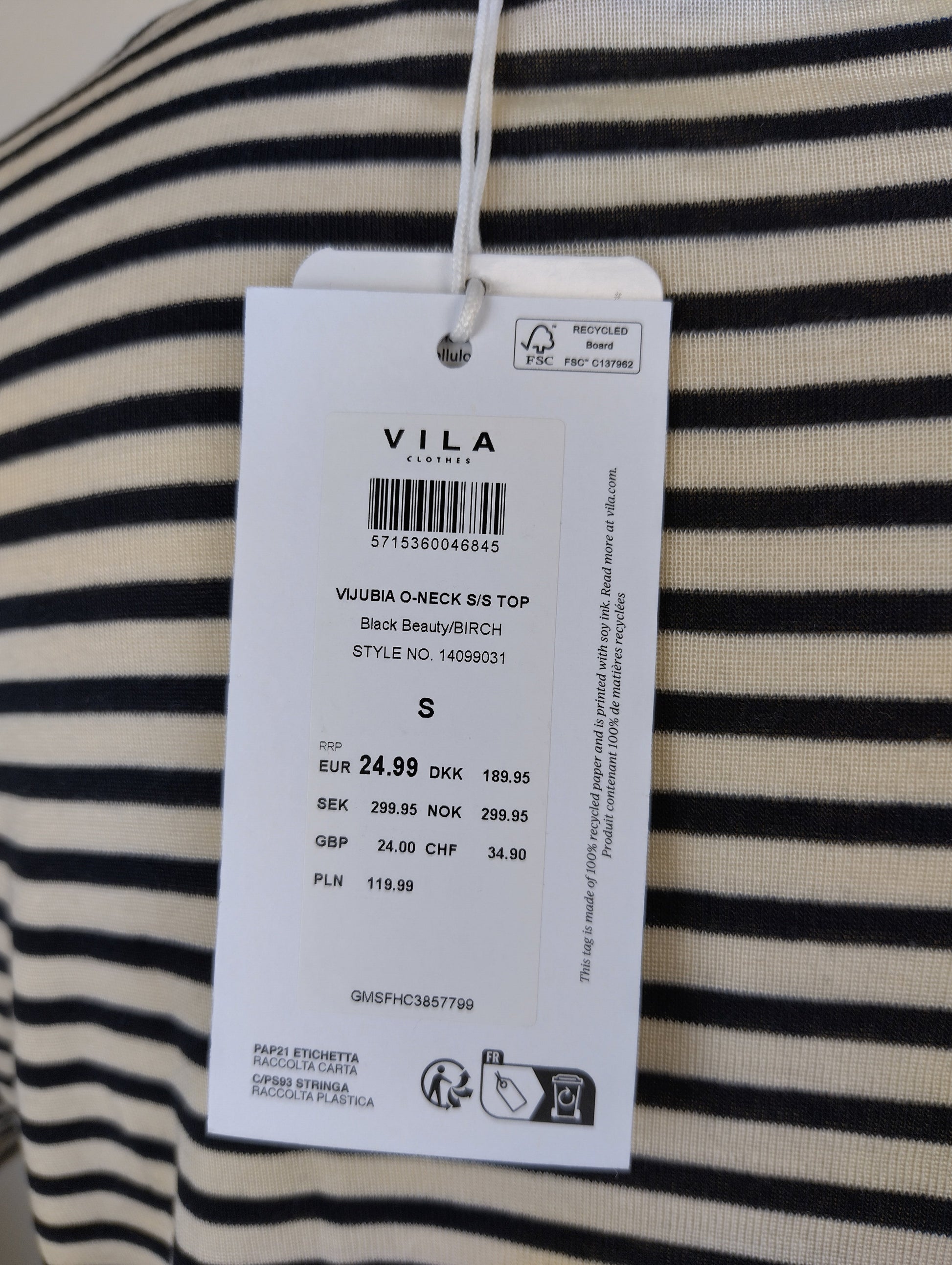 Close-up of Vila brand tag and size information on T-shirt