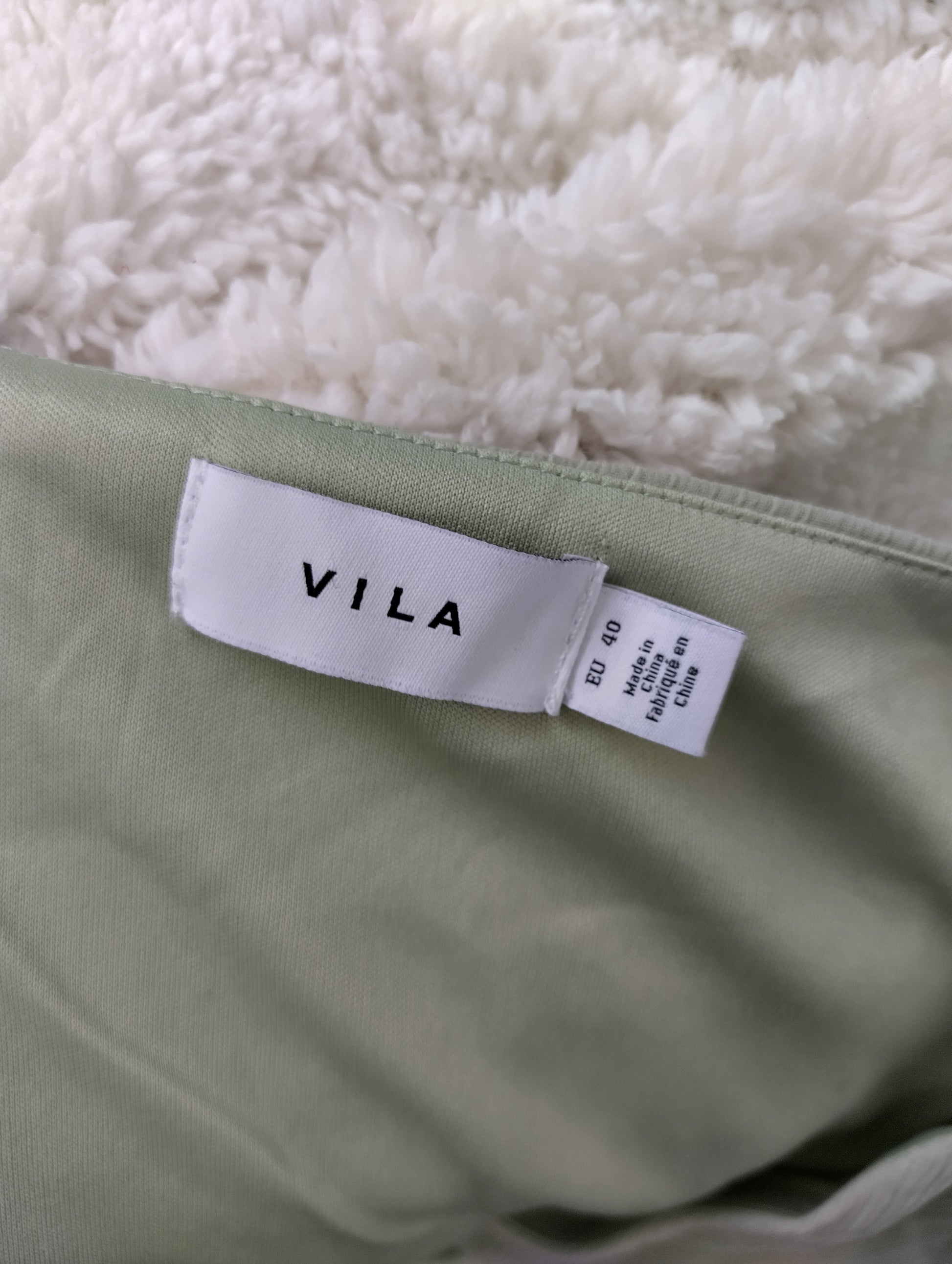 Vila brand tag on light green dress