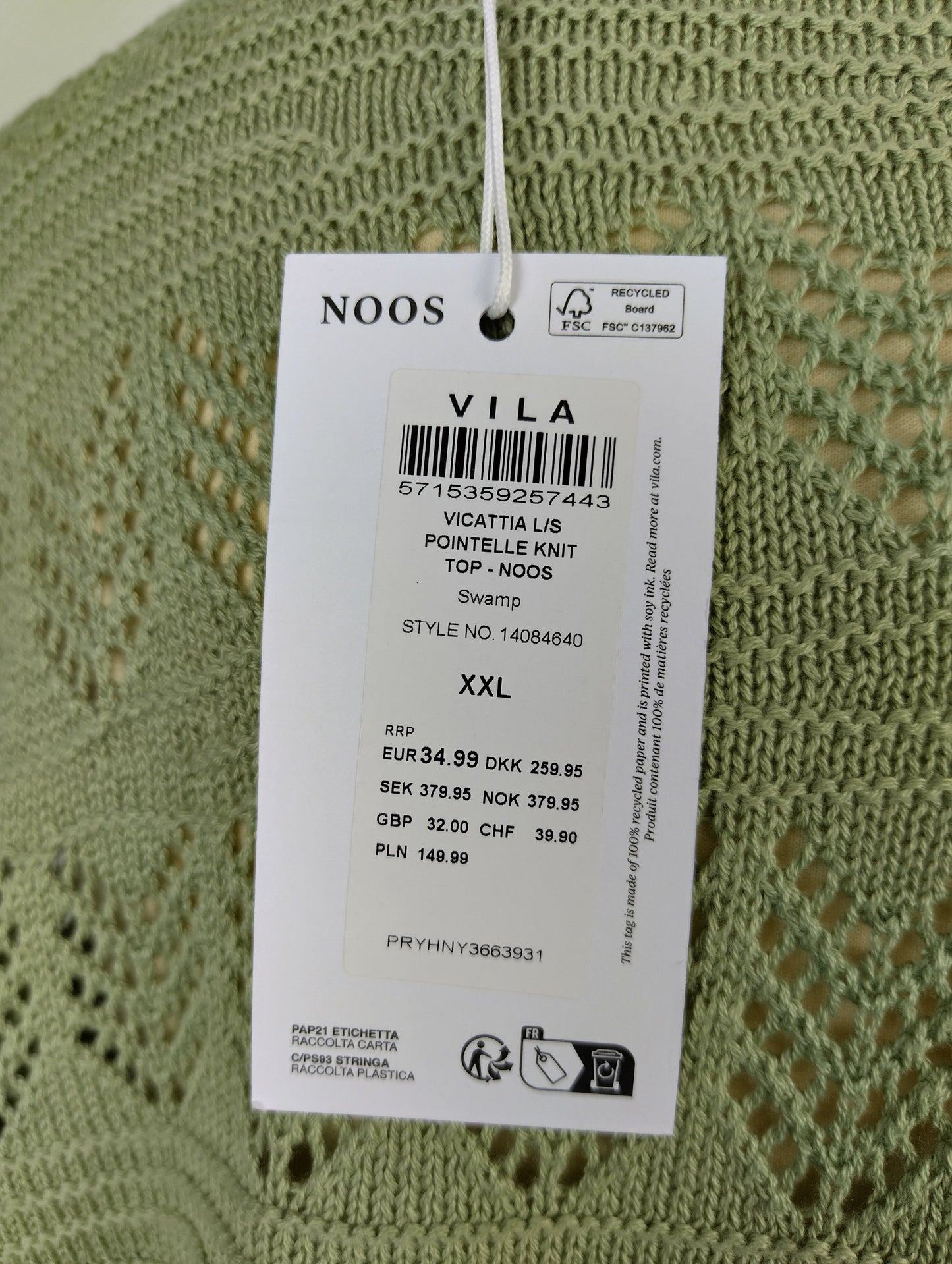 Close-up of Vila sweater tag showing details