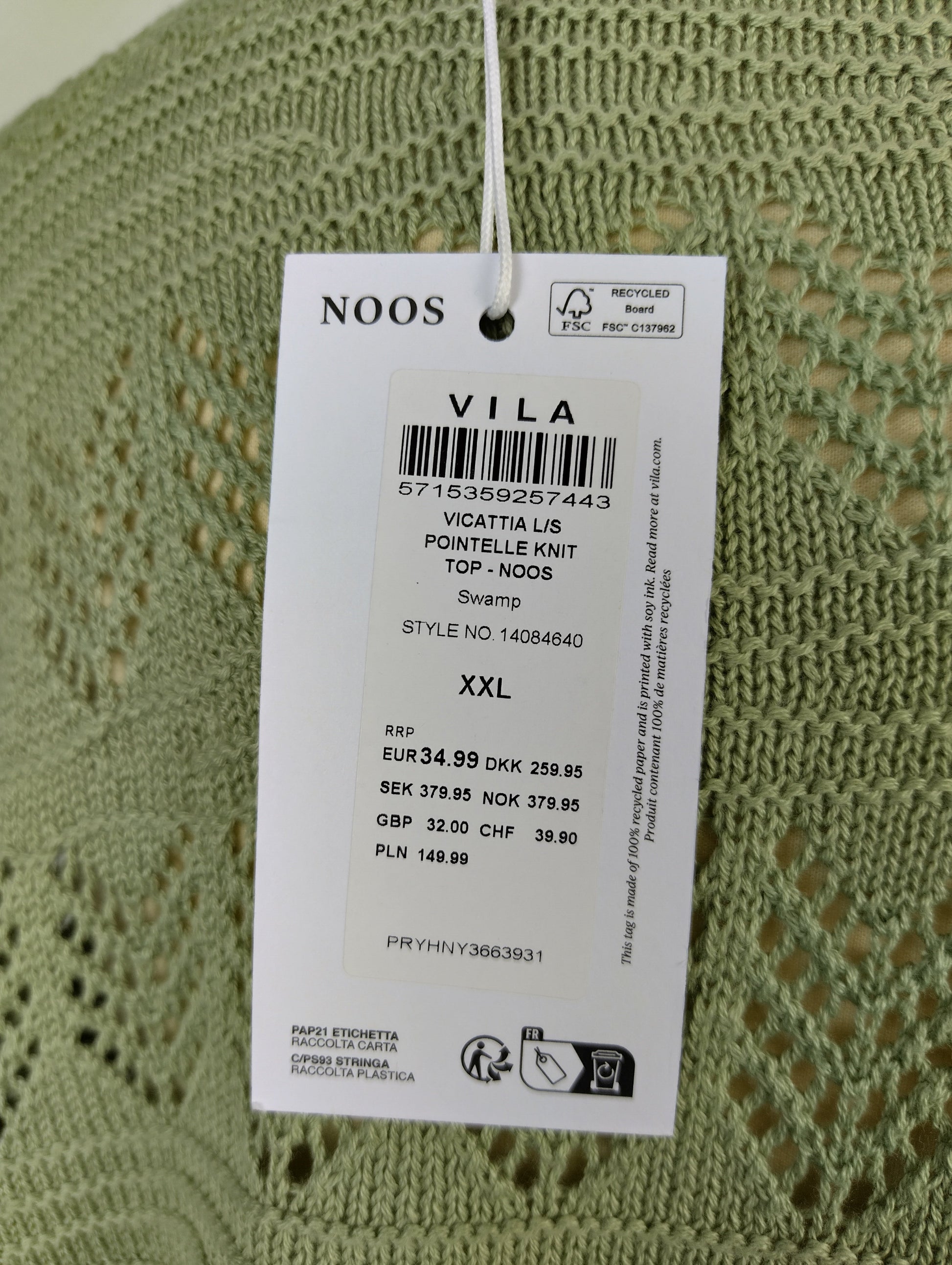 Close-up of Vila sweater tag showing details