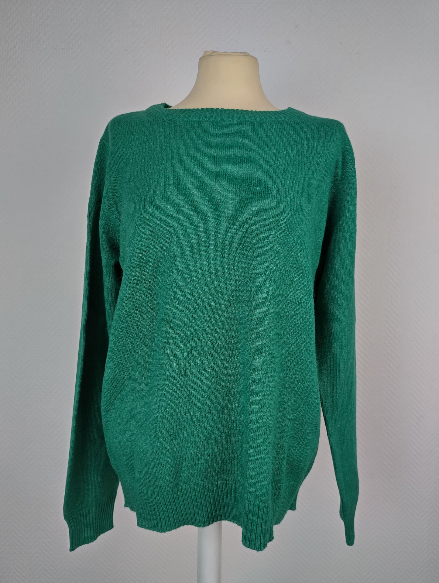 Front view of green knit sweater