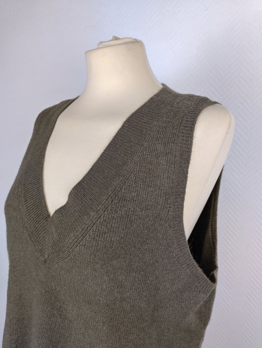 Olive green knit vest on mannequin close-up