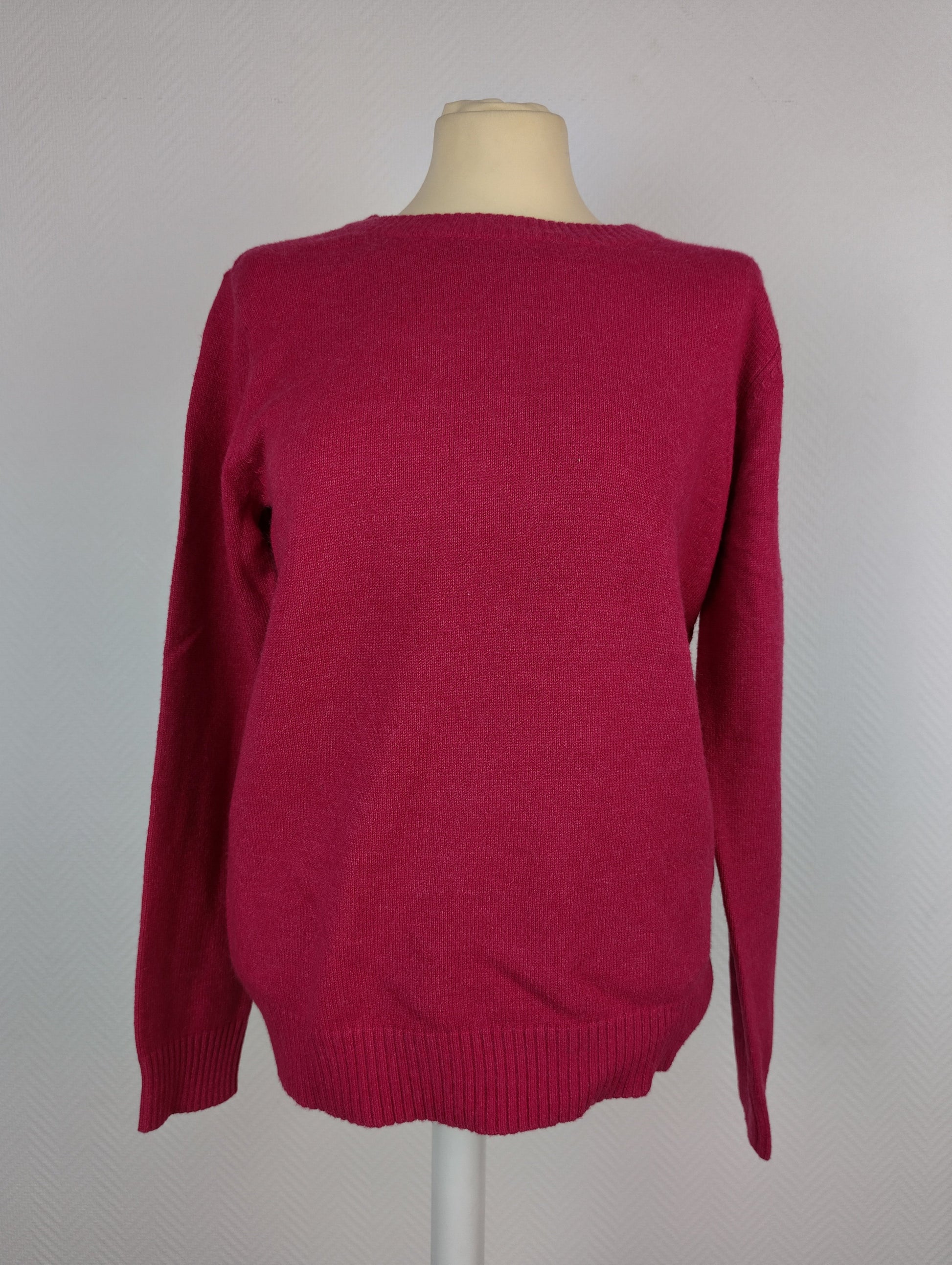 Front view of dark melon pink knit sweater on a mannequin
