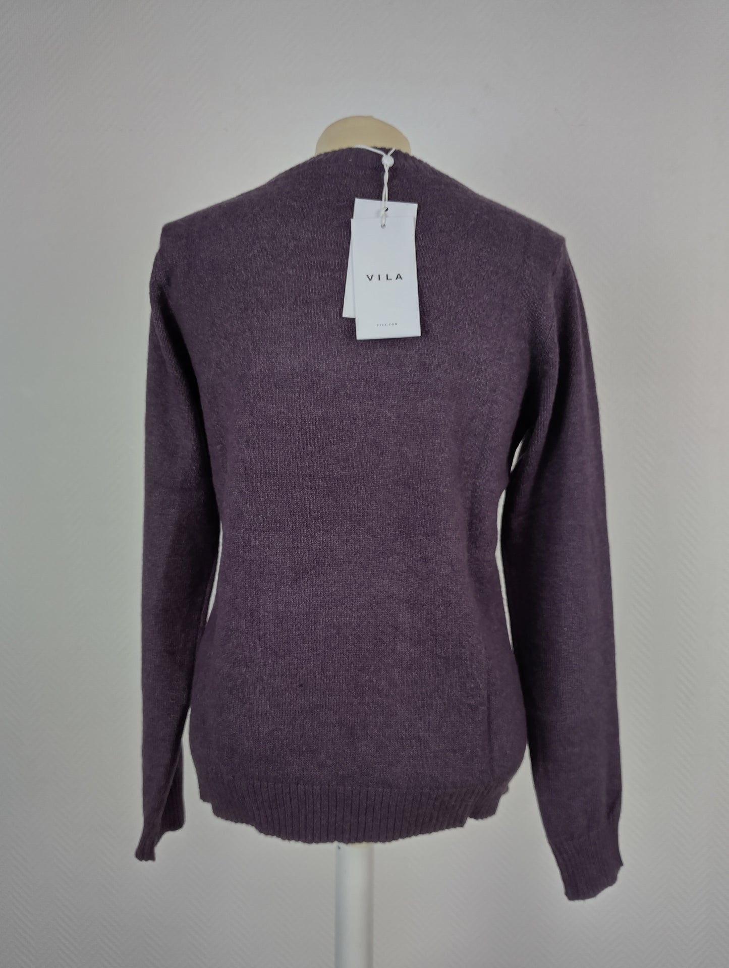 Back view of plum purple knit sweater with tag