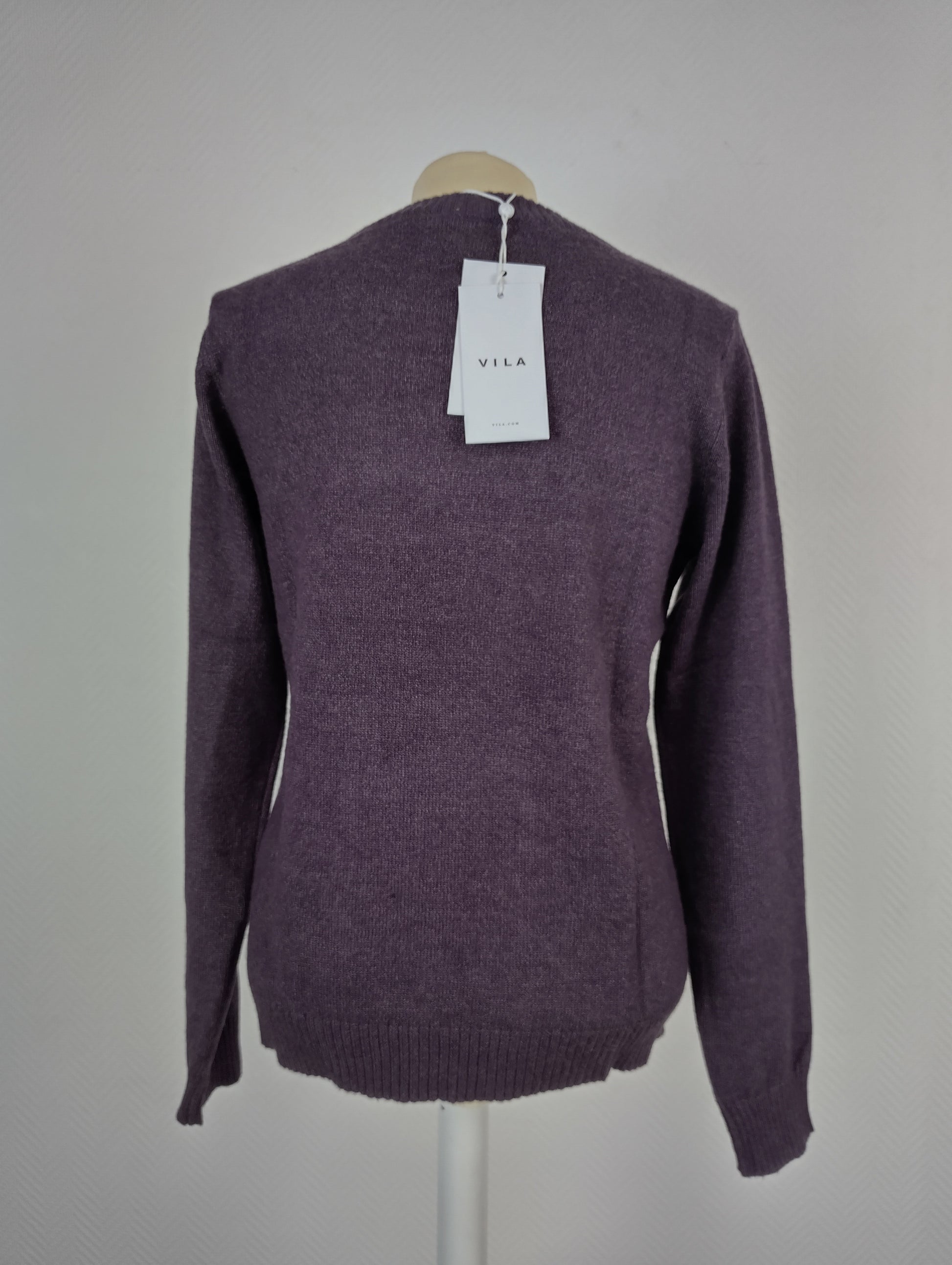 Back view of plum purple knit sweater with tag