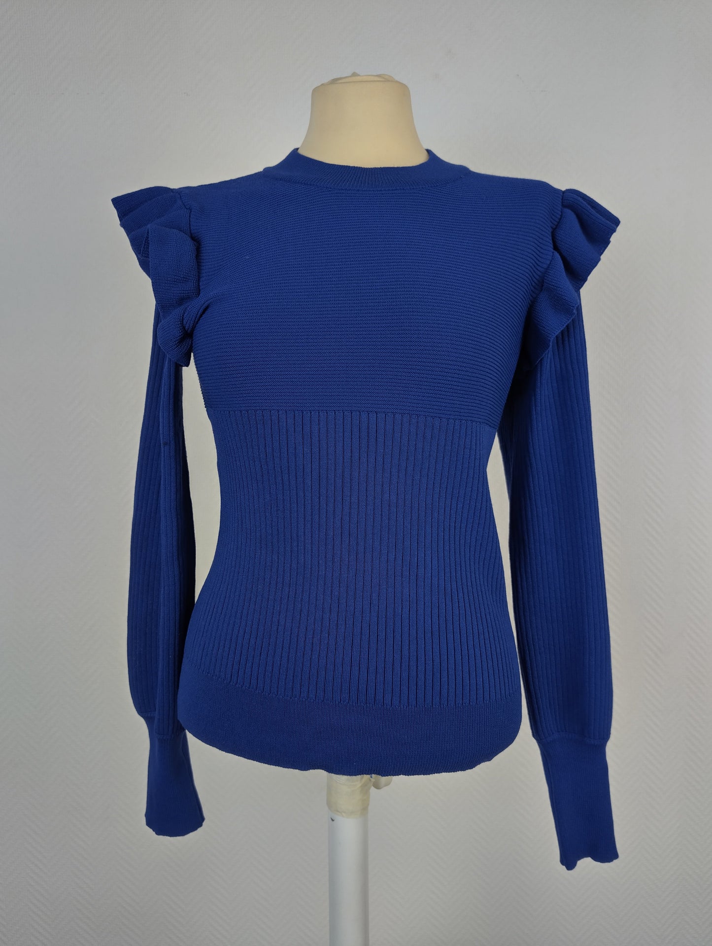 Front view of royal blue ruffle shoulder sweater