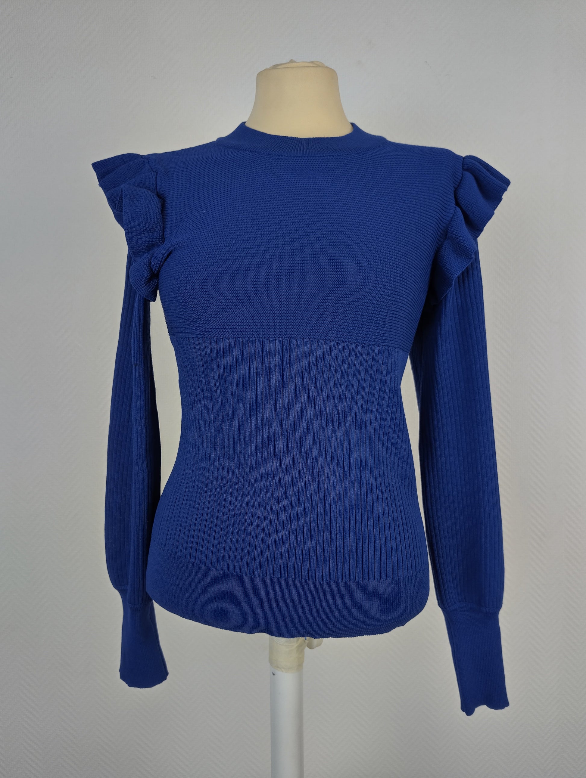Front view of royal blue ruffle shoulder sweater