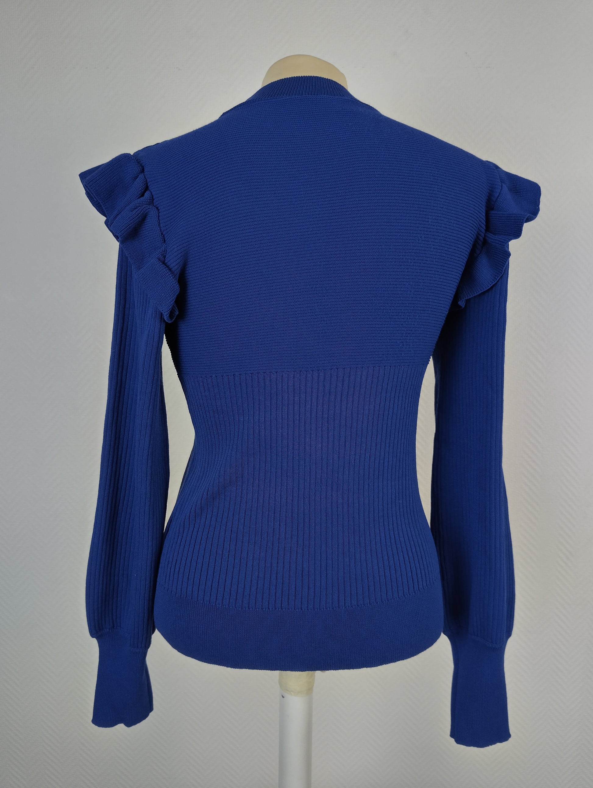 Back view of royal blue ruffle shoulder sweater