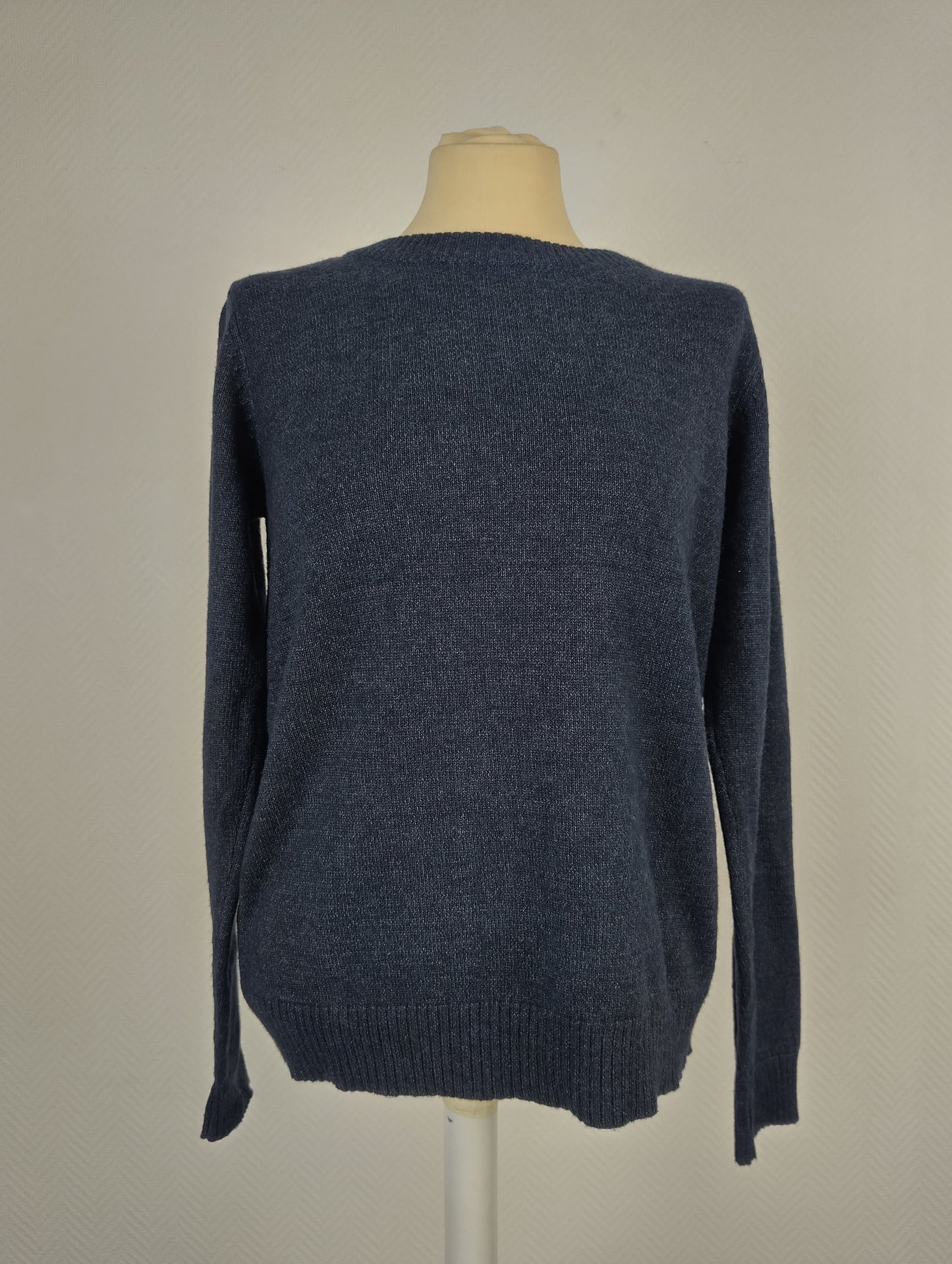 Front view of blue knit sweater on mannequin