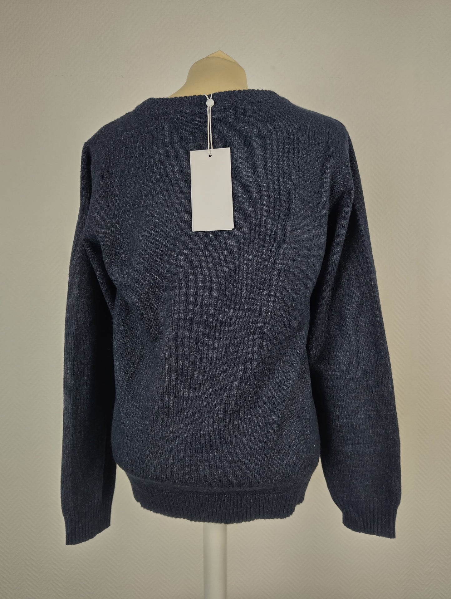 Back view of blue knit sweater with tag