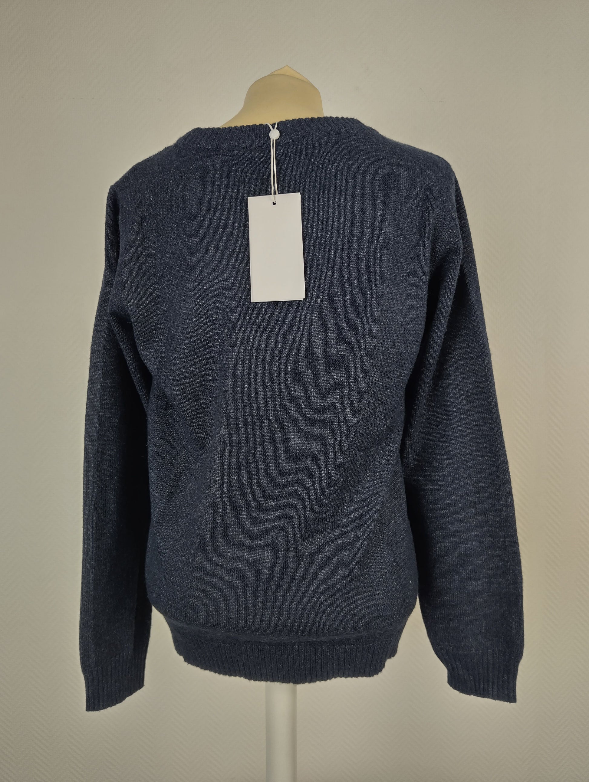 Back view of blue knit sweater with tag