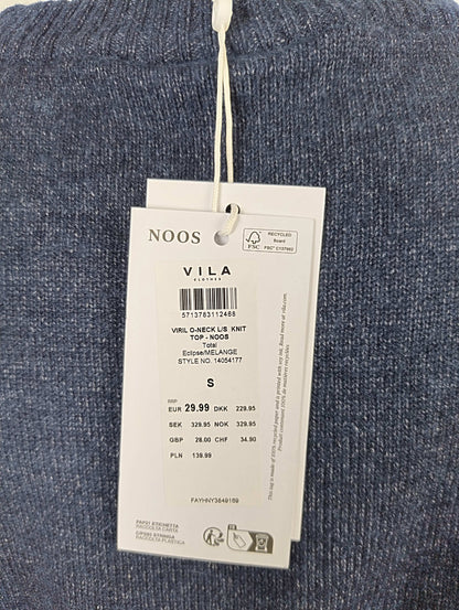 Close-up of tag details on blue knit sweater