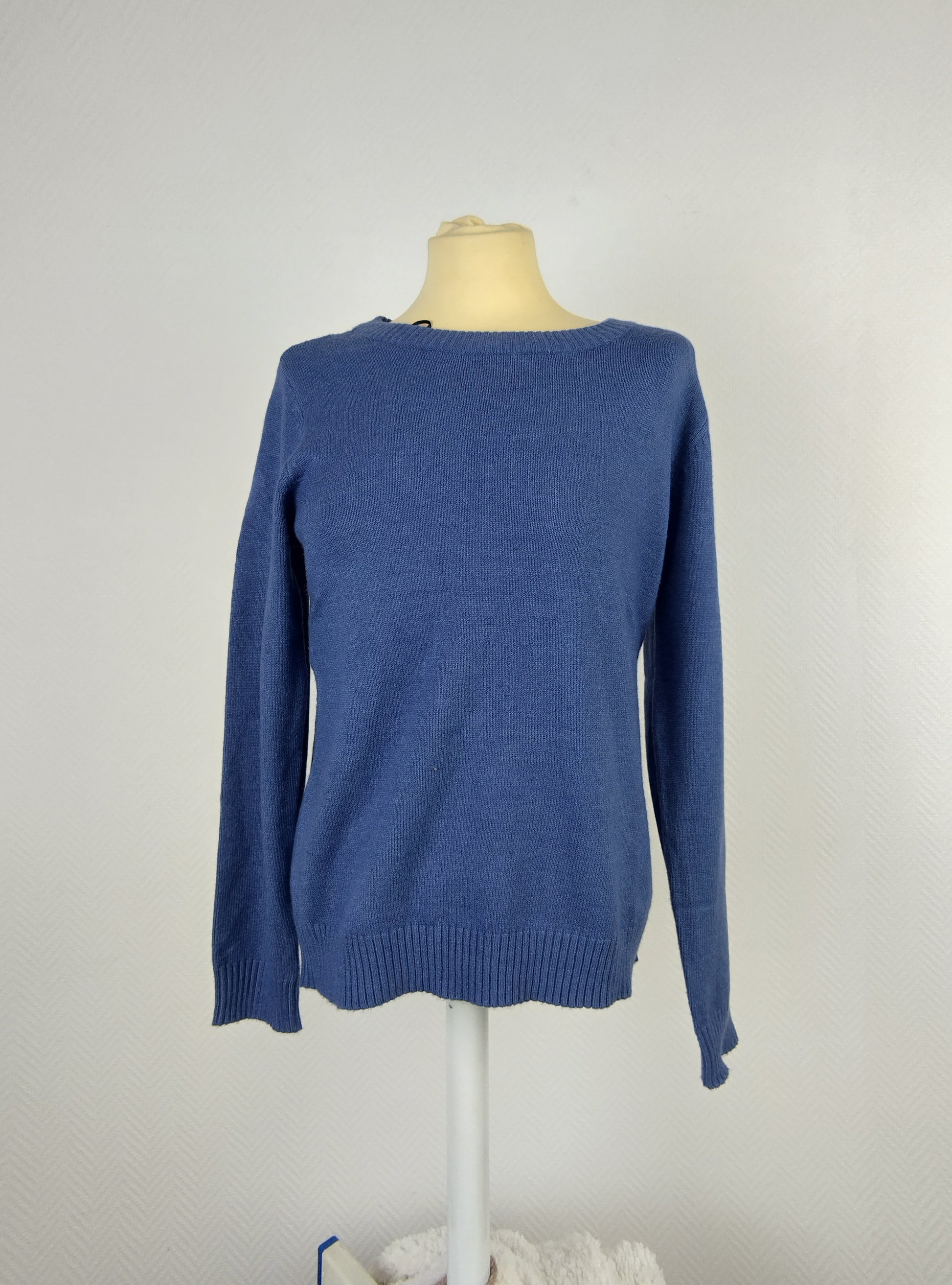 Front view of blue knit sweater on mannequin
