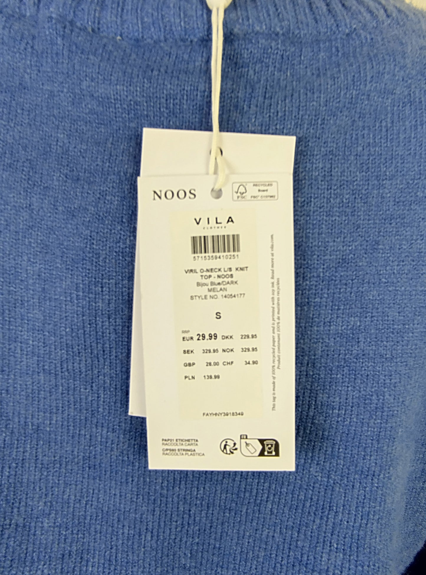 Close-up of tag on blue knit sweater