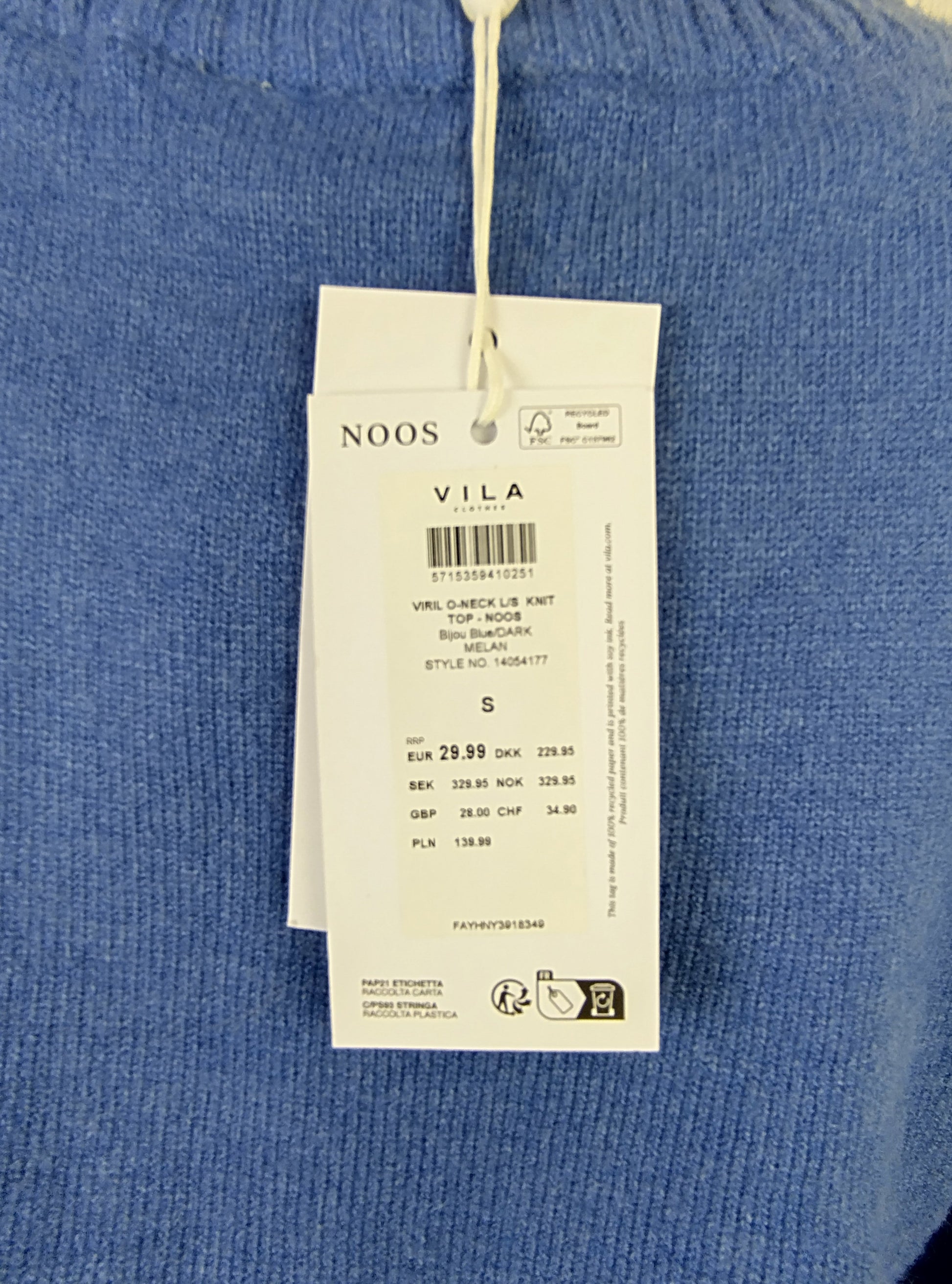 Close-up of tag on blue knit sweater