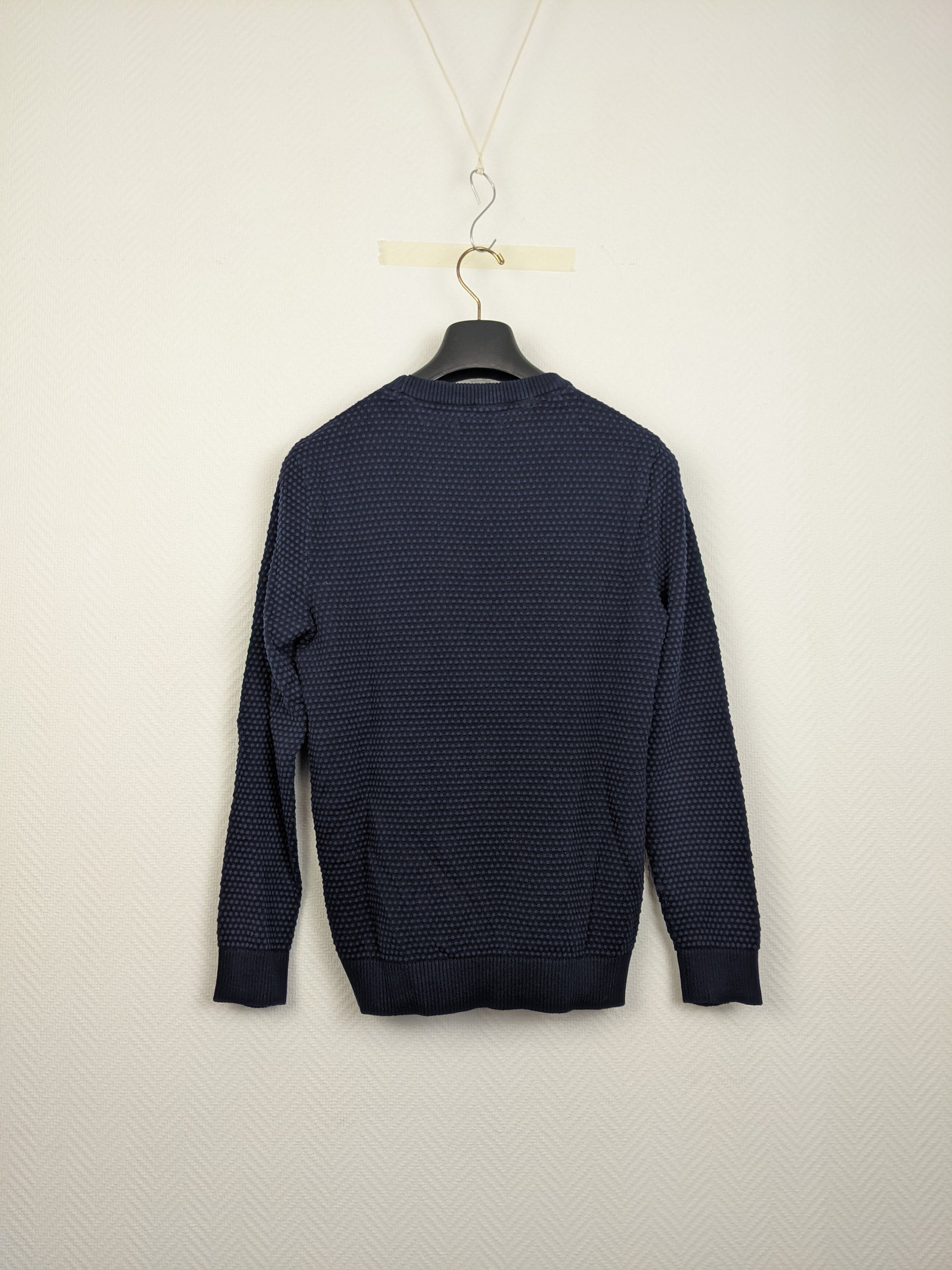 Back view of navy blue textured sweater