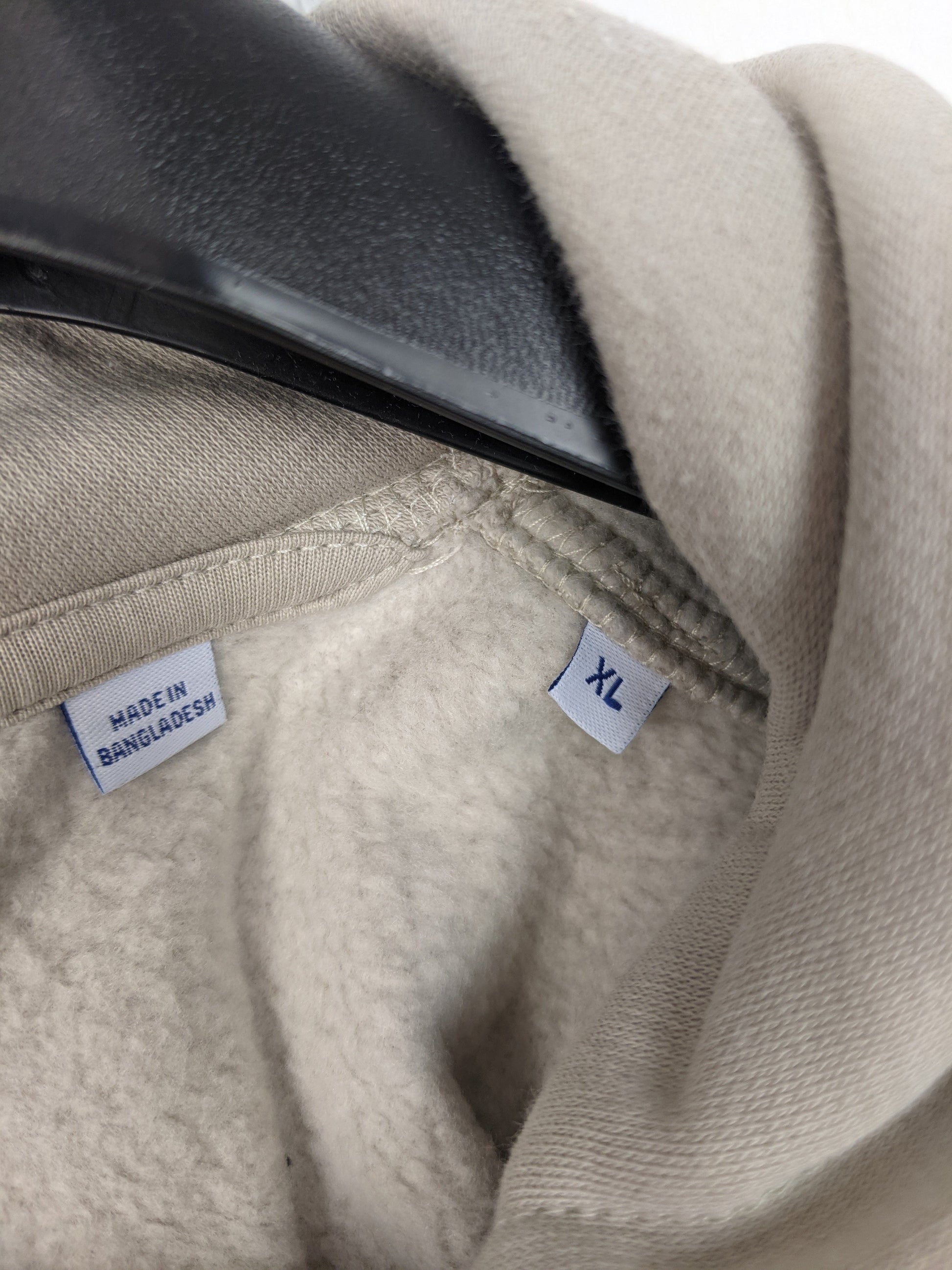 Size and origin label of the hoodie showing XL