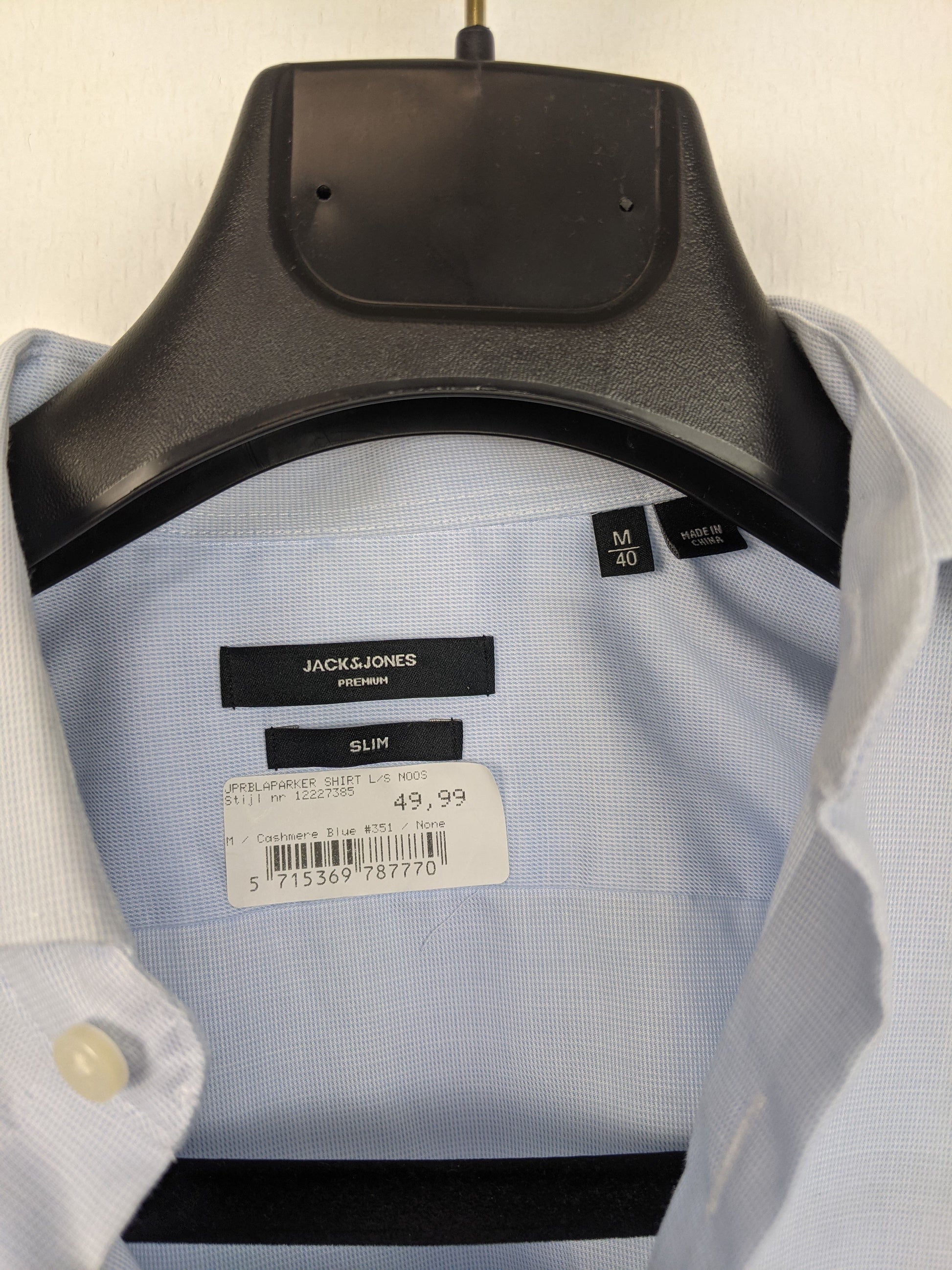 Close-up of Jack & Jones shirt label showing size and brand