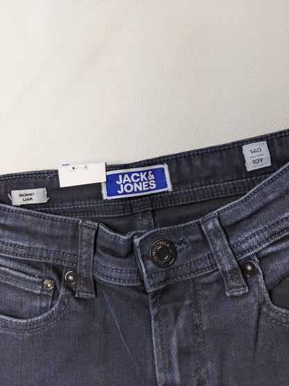 Close-up of Jack & Jones logo and size on dark wash skinny jeans