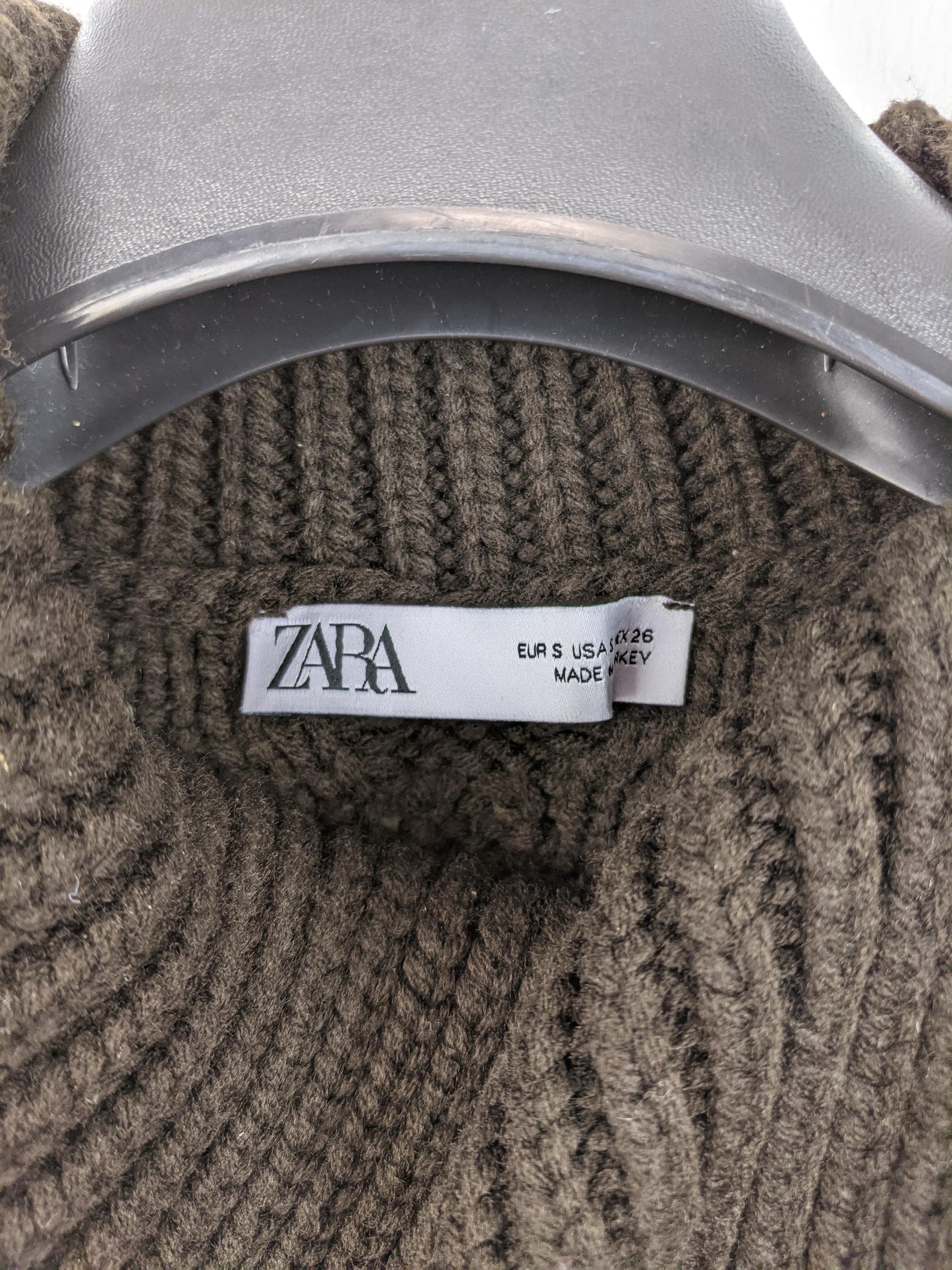 Close-up of Zara label on brown knit vest