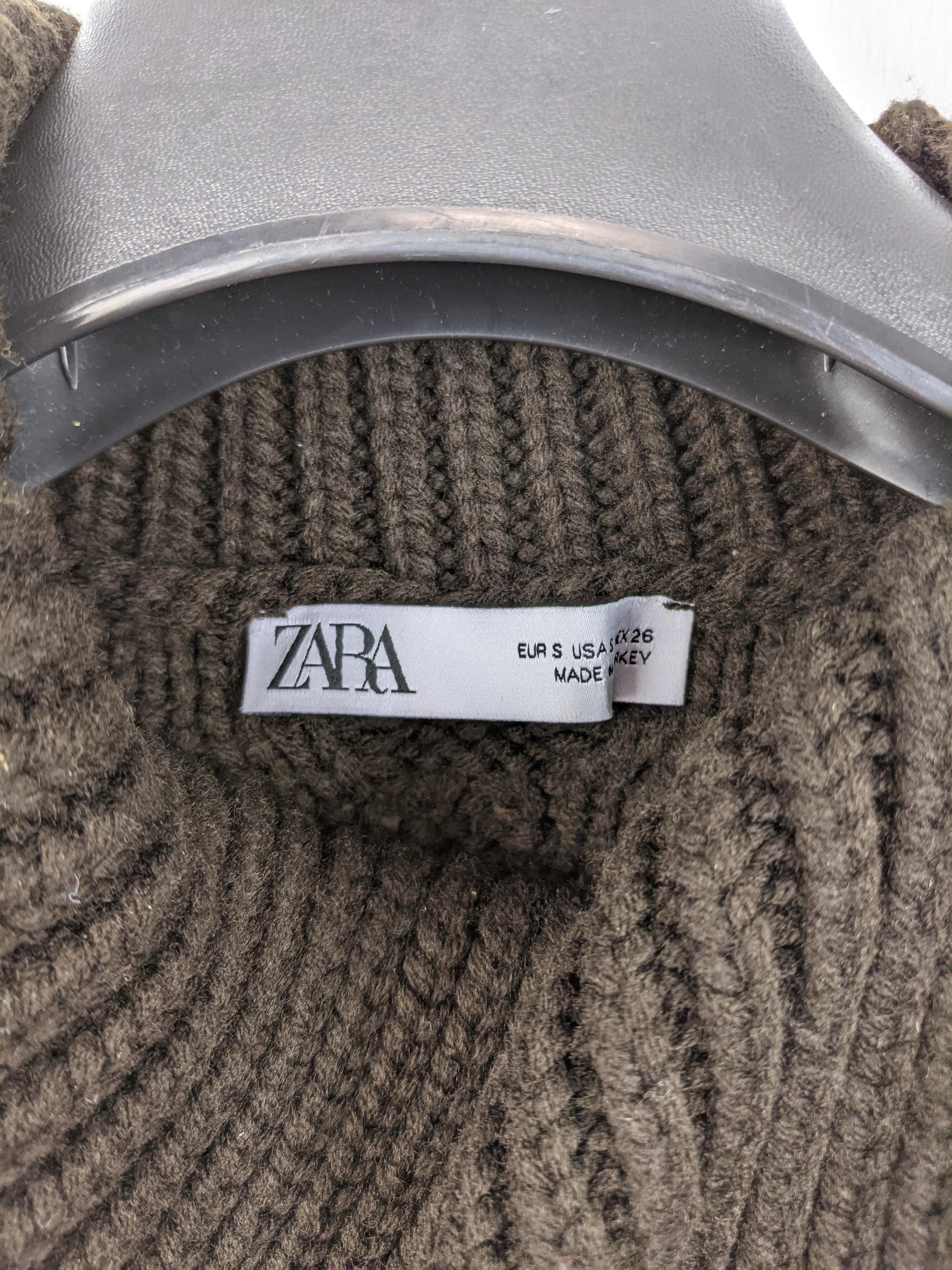 Close-up of Zara label on brown knit vest