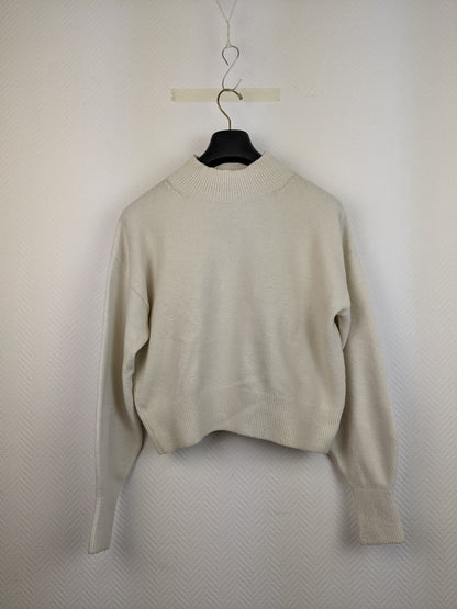 Front view of cream knit sweater on hanger
