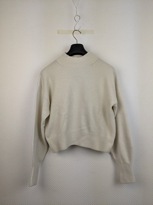 Front view of cream knit sweater on hanger