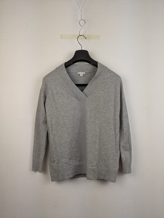 Front view of gray V-neck sweater on hanger