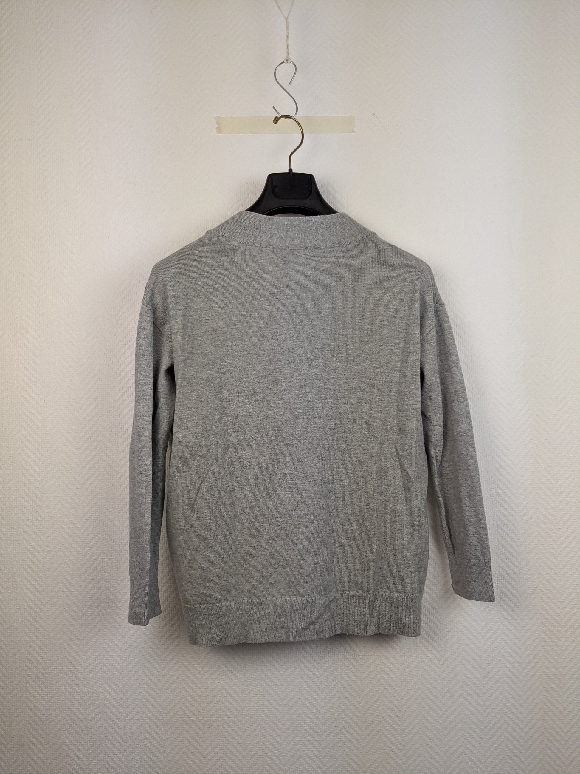Back view of gray V-neck sweater on hanger