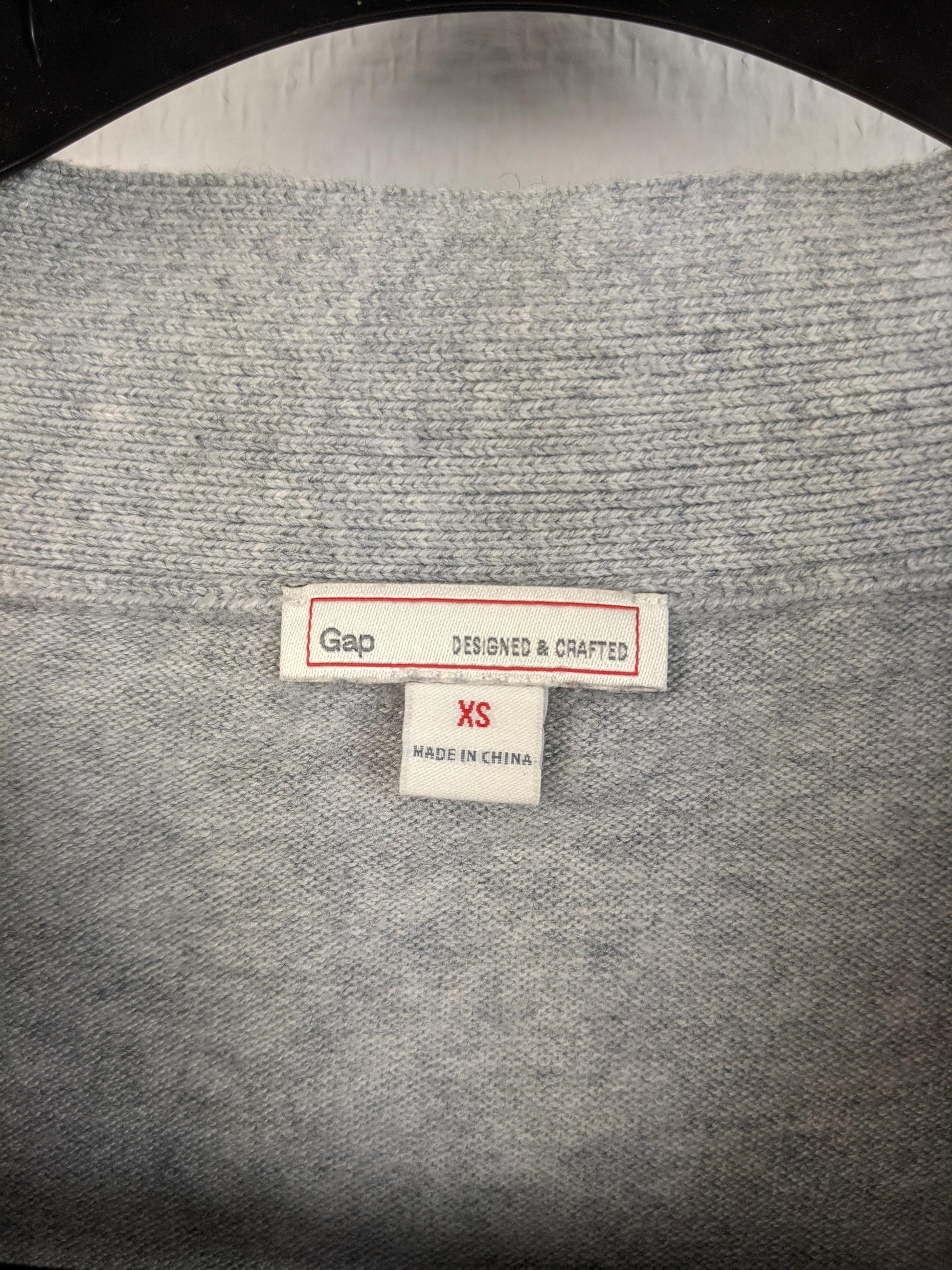 Close-up of Gap label and size tag showing XS