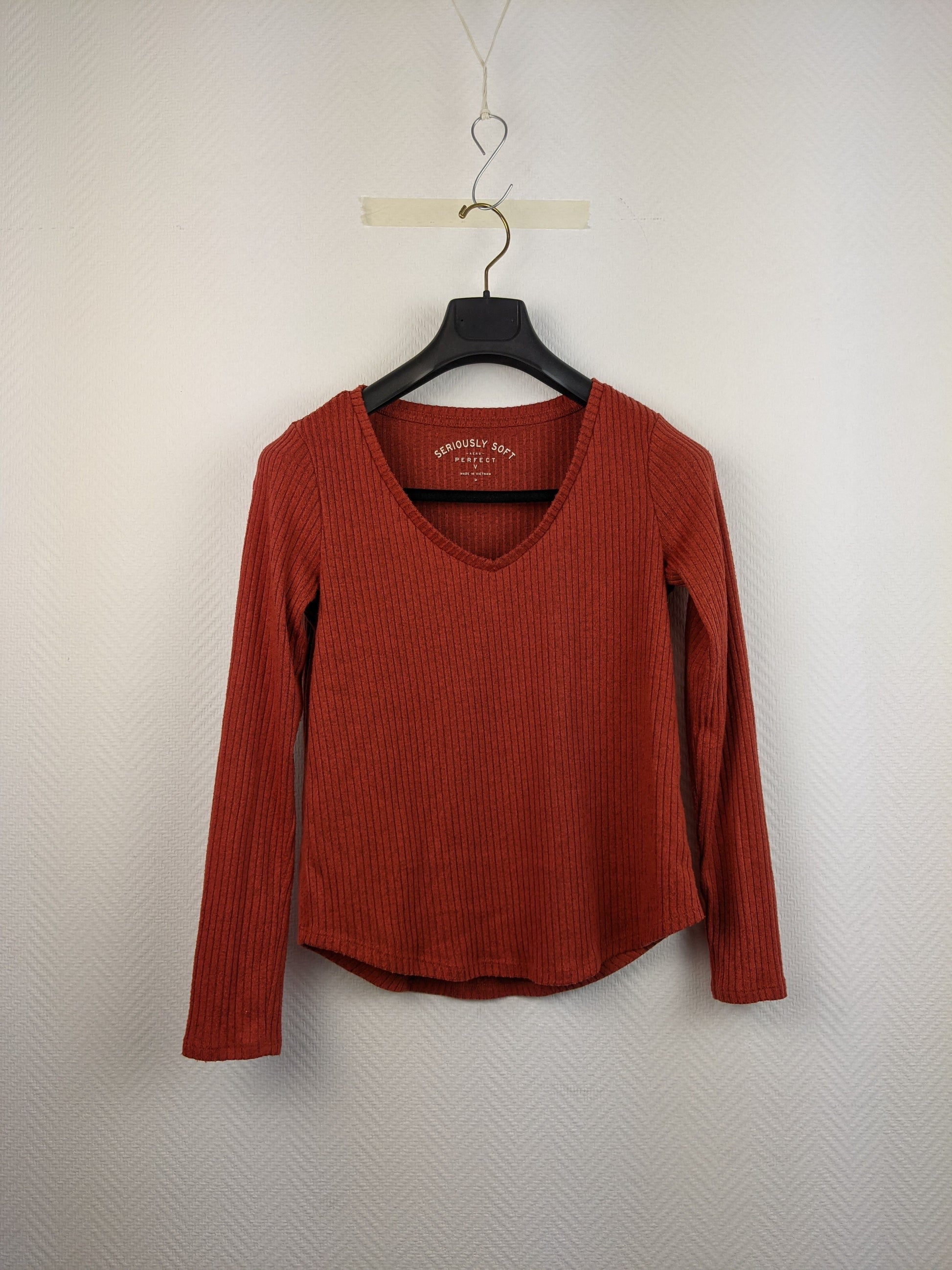 Front view of red ribbed long-sleeve top