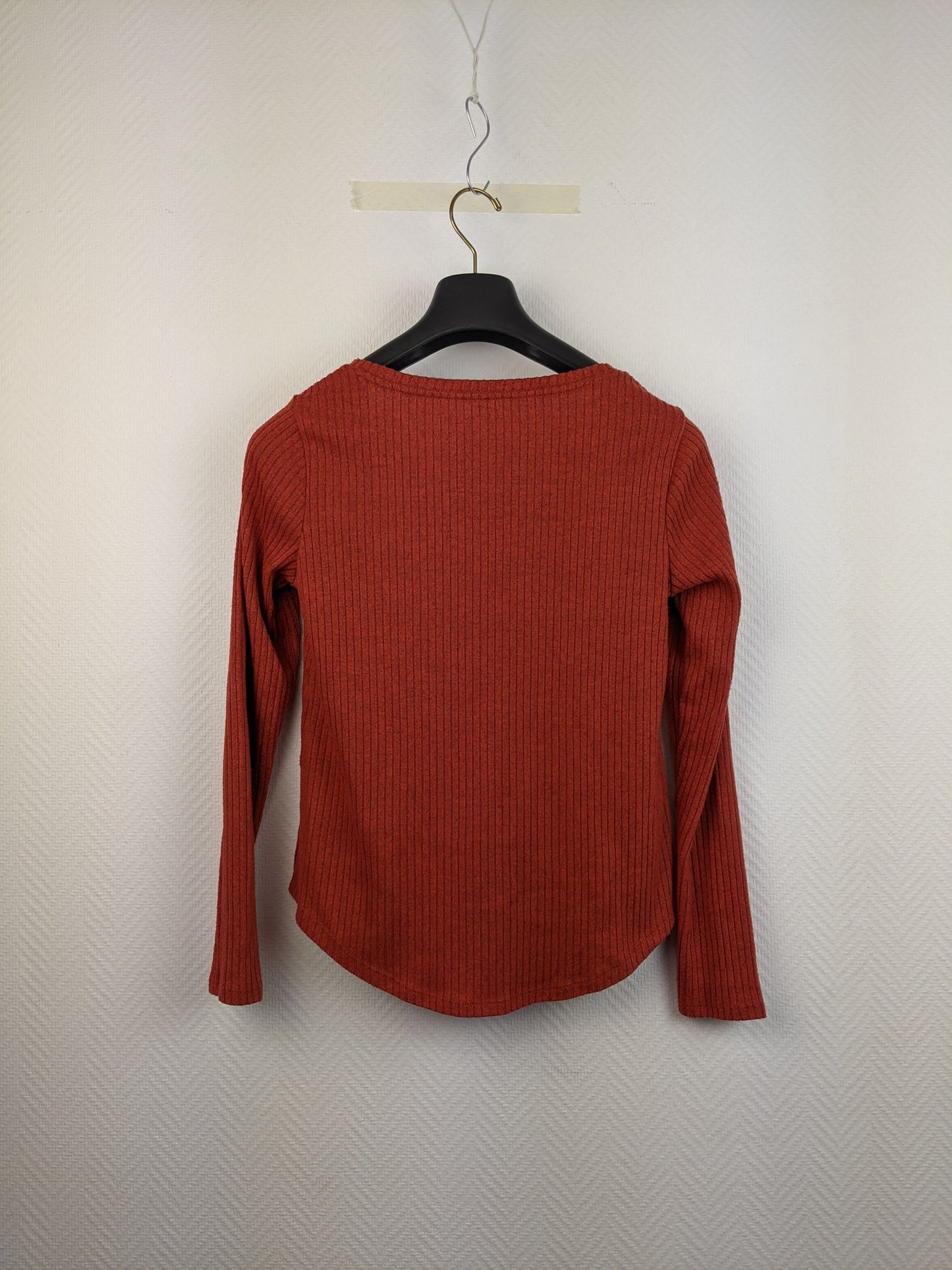 Back view of red ribbed long-sleeve top