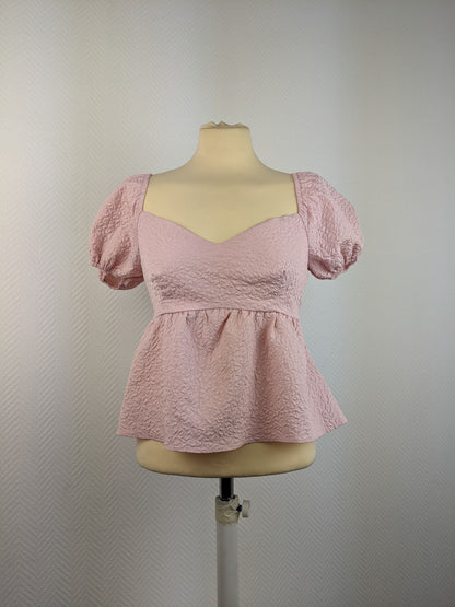 Front view of pink textured puff sleeve top