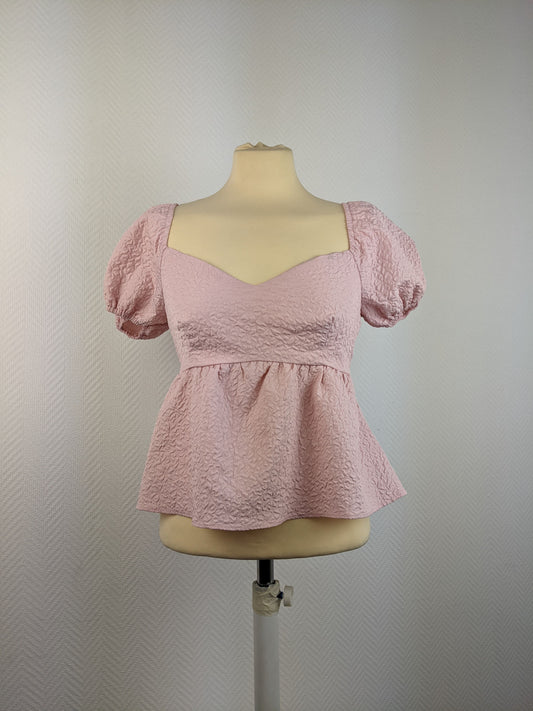 Front view of pink textured puff sleeve top