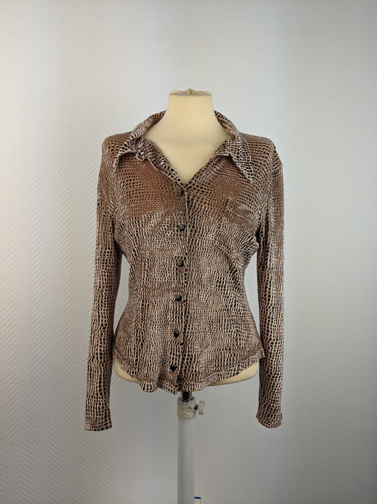 Front view of animal print blouse on mannequin